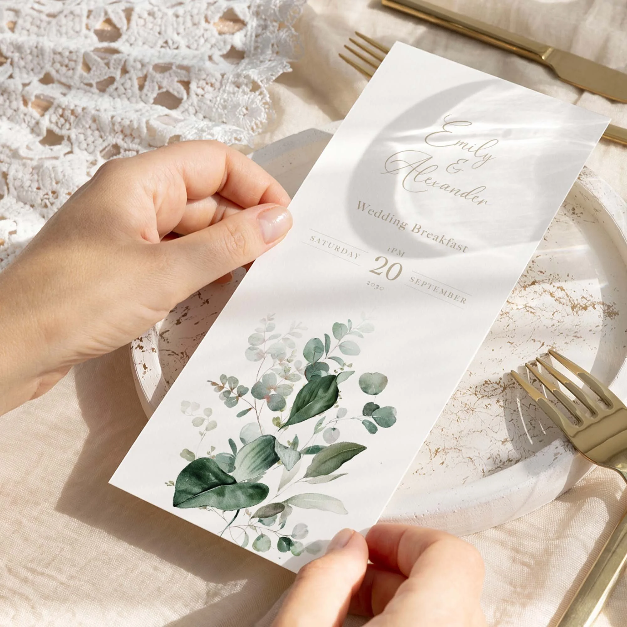 Hand holding Emerald Greenery wedding menu card showing size and printed design details