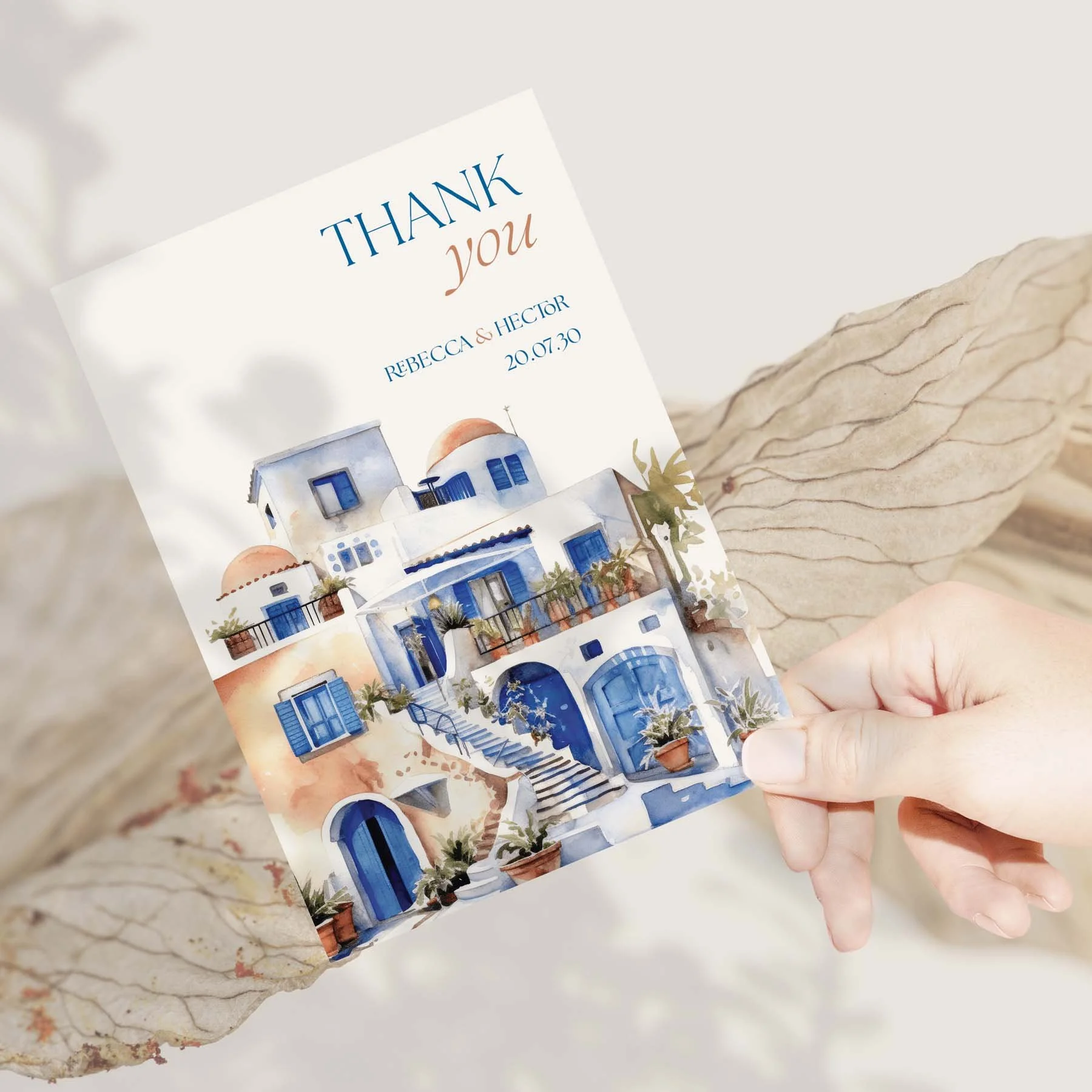 Hand holding a Santorini wedding thank you card
