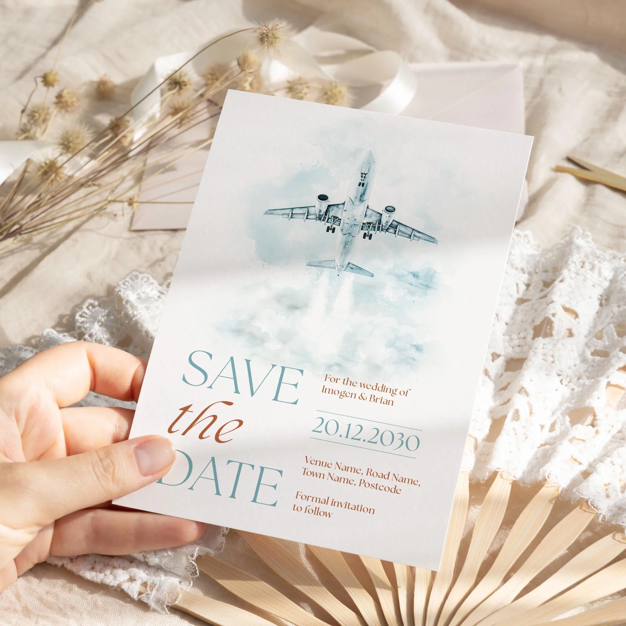 Person holding the Explorer Save the Date in duck egg blue and brown vintage tones.