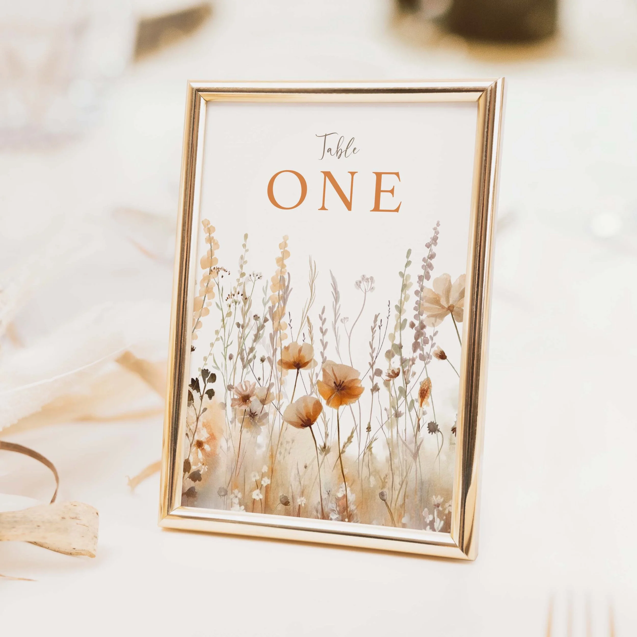 Field Harvest wedding table number with dried grass and wildflower botanical illustration in terracotta tones on luxury off-white card