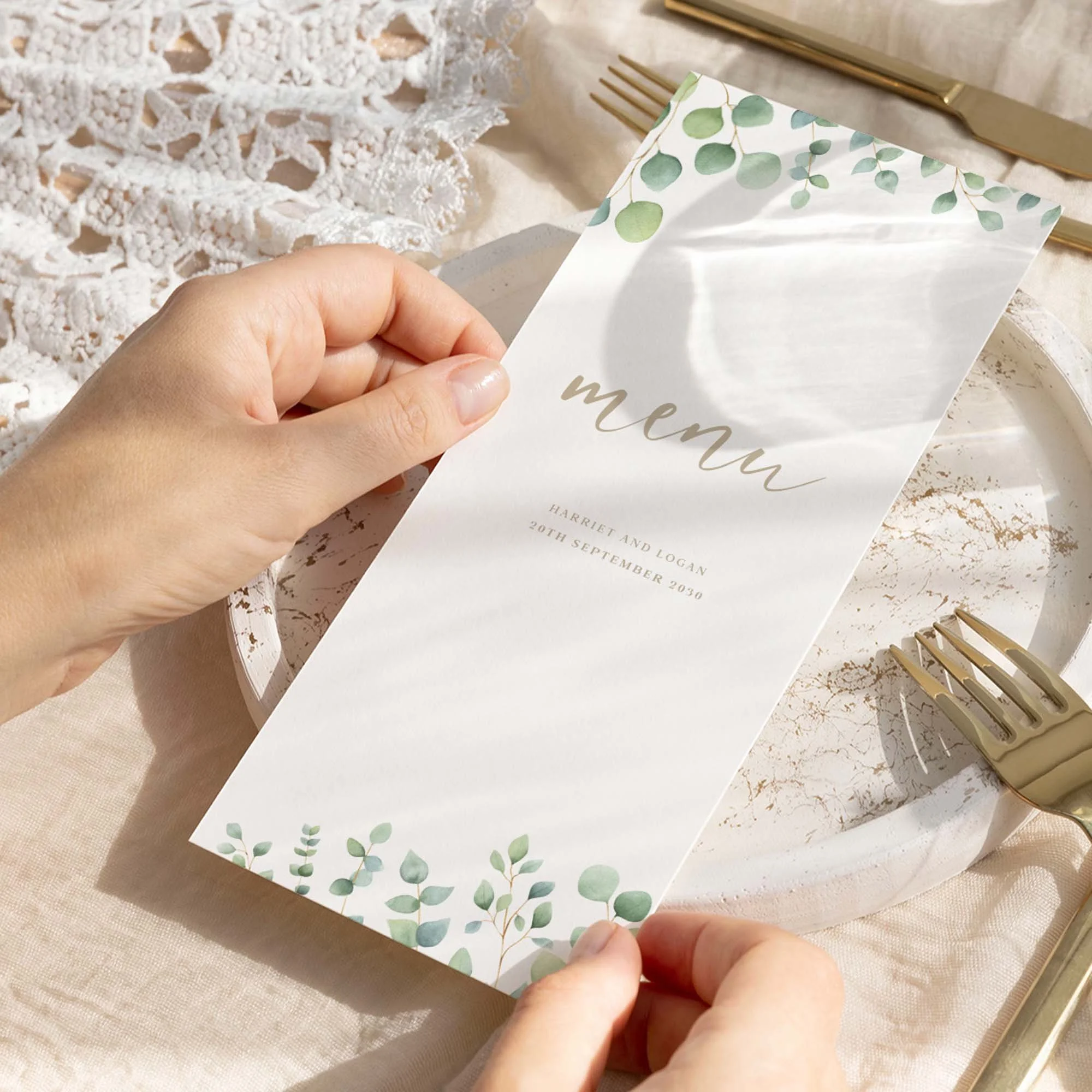 Hand holding Eucalyptus Calligraphy wedding menu card showing size and printed design details
