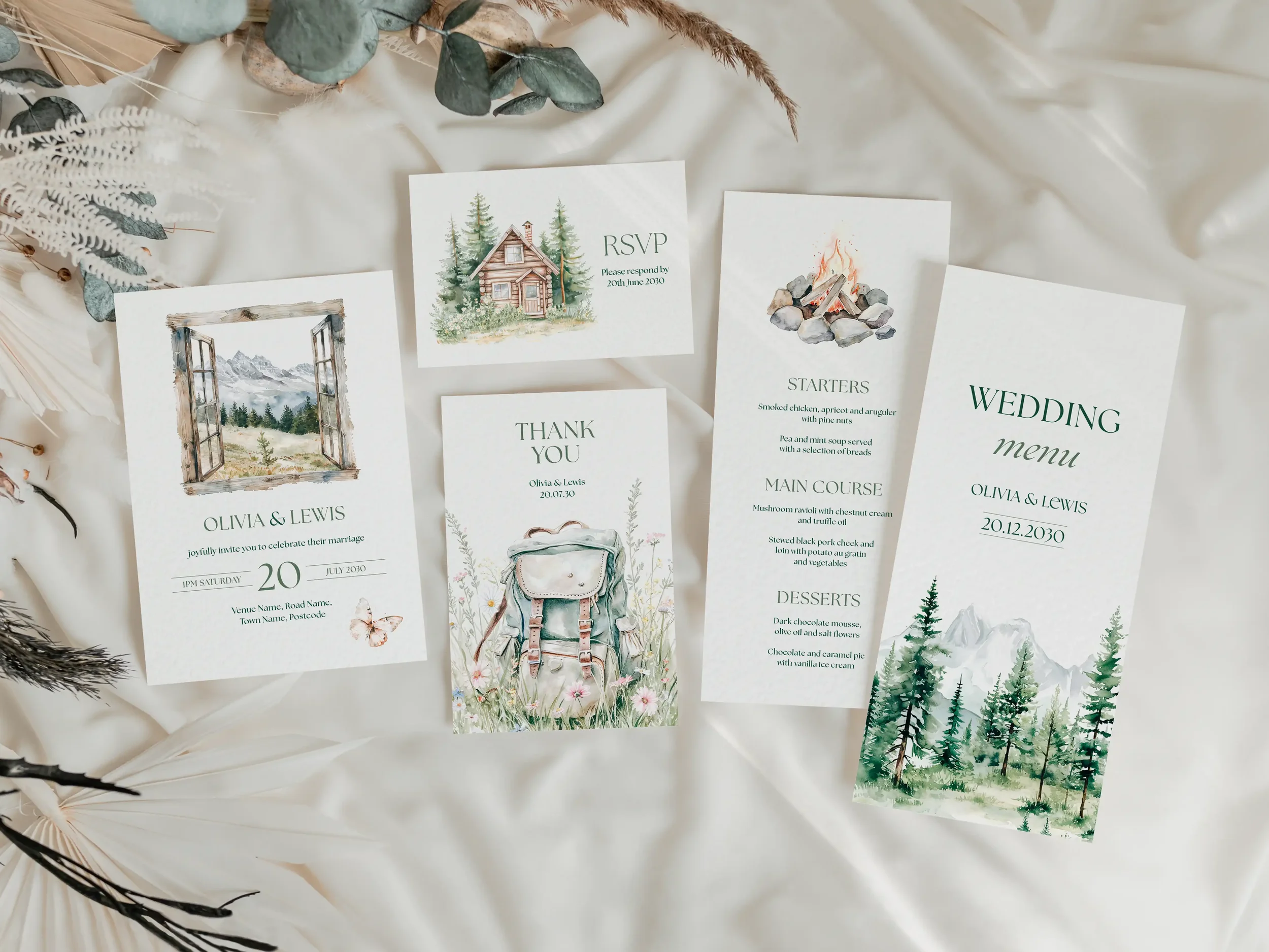 Full Adventure wedding stationery suite flat lay showing invitations, RSVP cards and coordinating pieces with illustrated outdoor adventure scenes