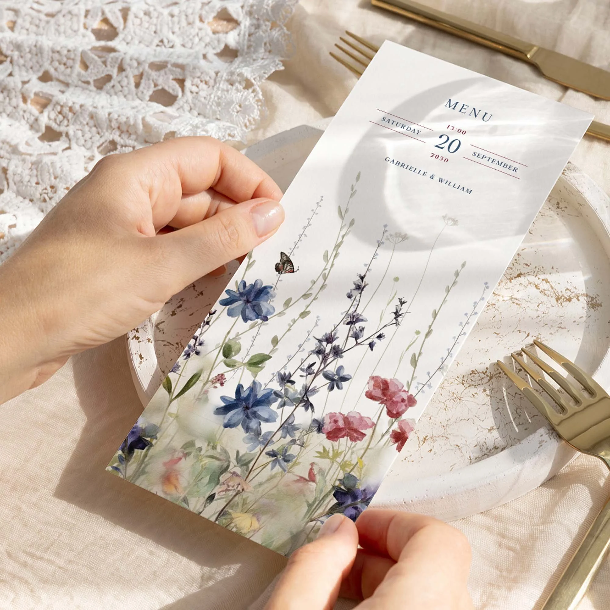 Hand holding Navy Blue and Red Wildflowers wedding menu card showing size and printed design details