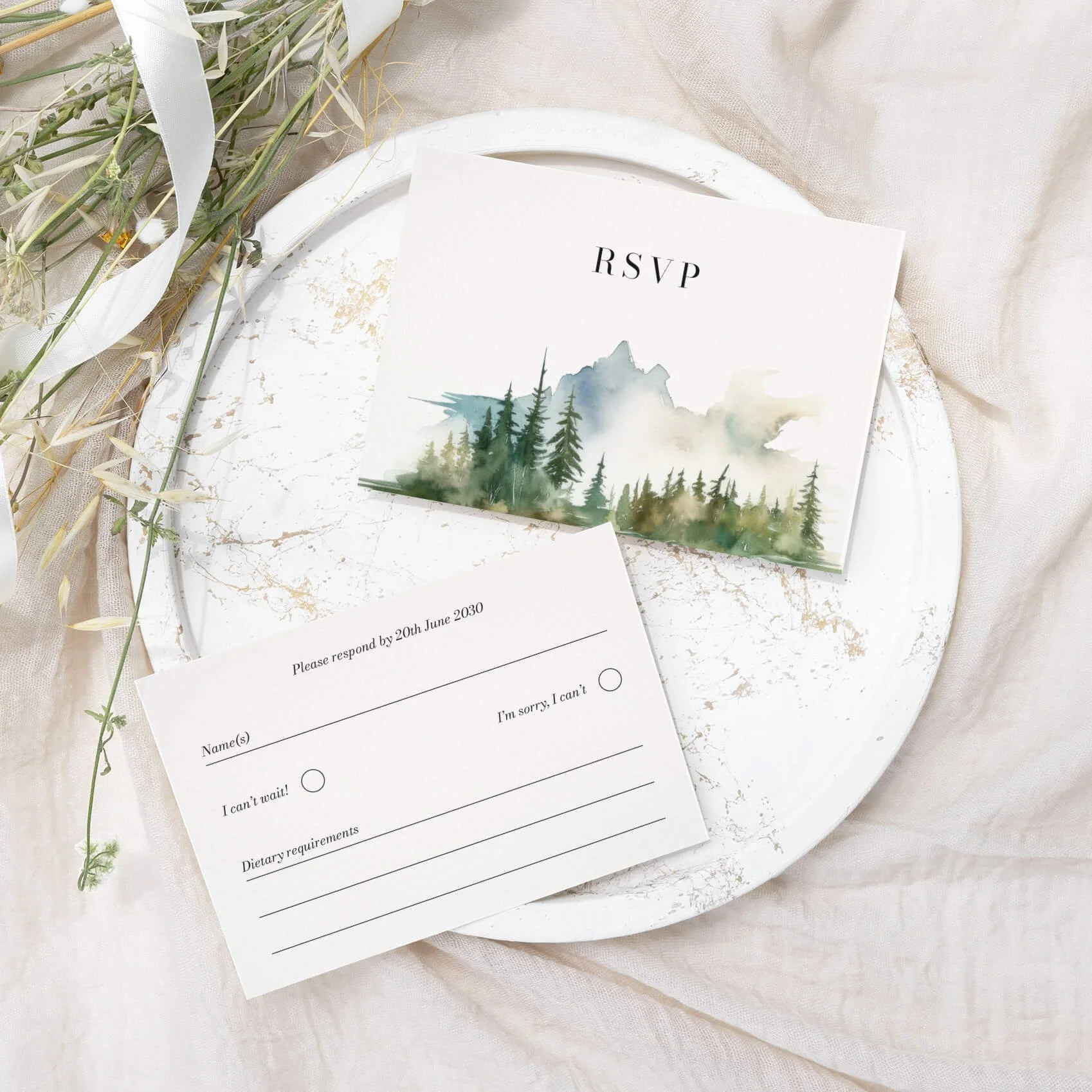 Wilderness wedding RSVP card with watercolour mountain and pine forest landscape illustration on luxury off-white card