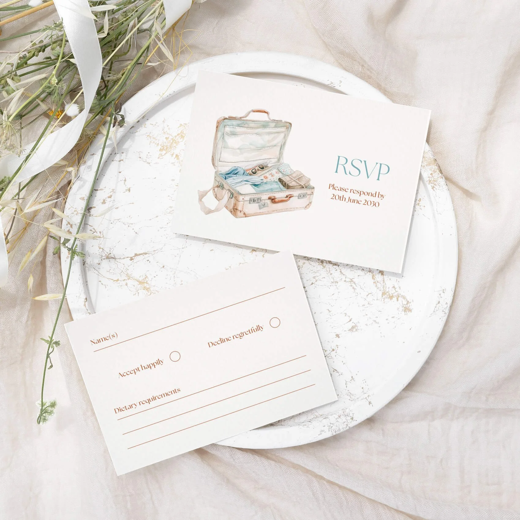 Travel themed wedding RSVP card with illustrated suitcase and response details