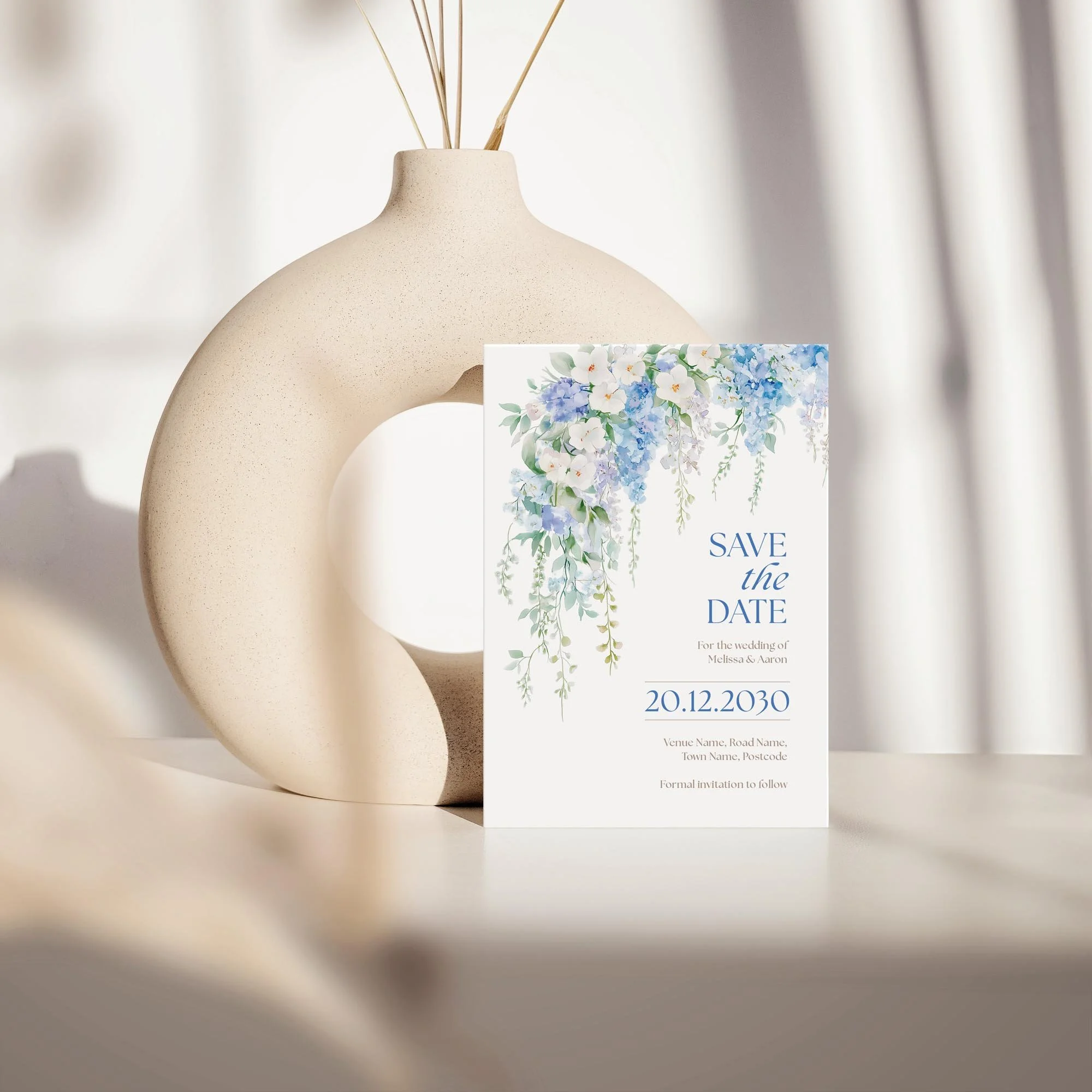 Elevated upright view of the Serenity Save the Date featuring romantic blue floral artwork.