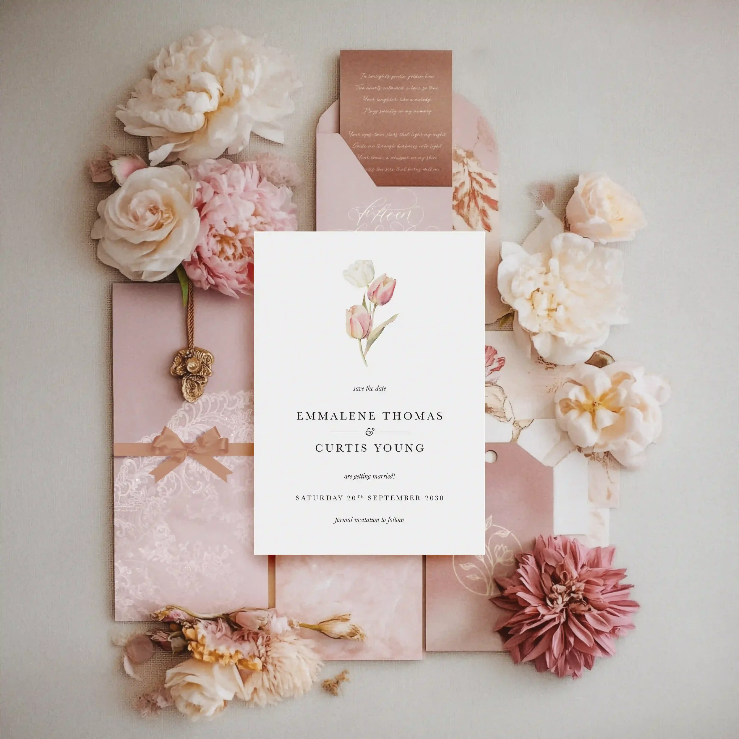 Blush pink wedding save the date flat lay styled with fresh peonies and roses, featuring a botanical invitation suite from Wonder Wedding Stationery