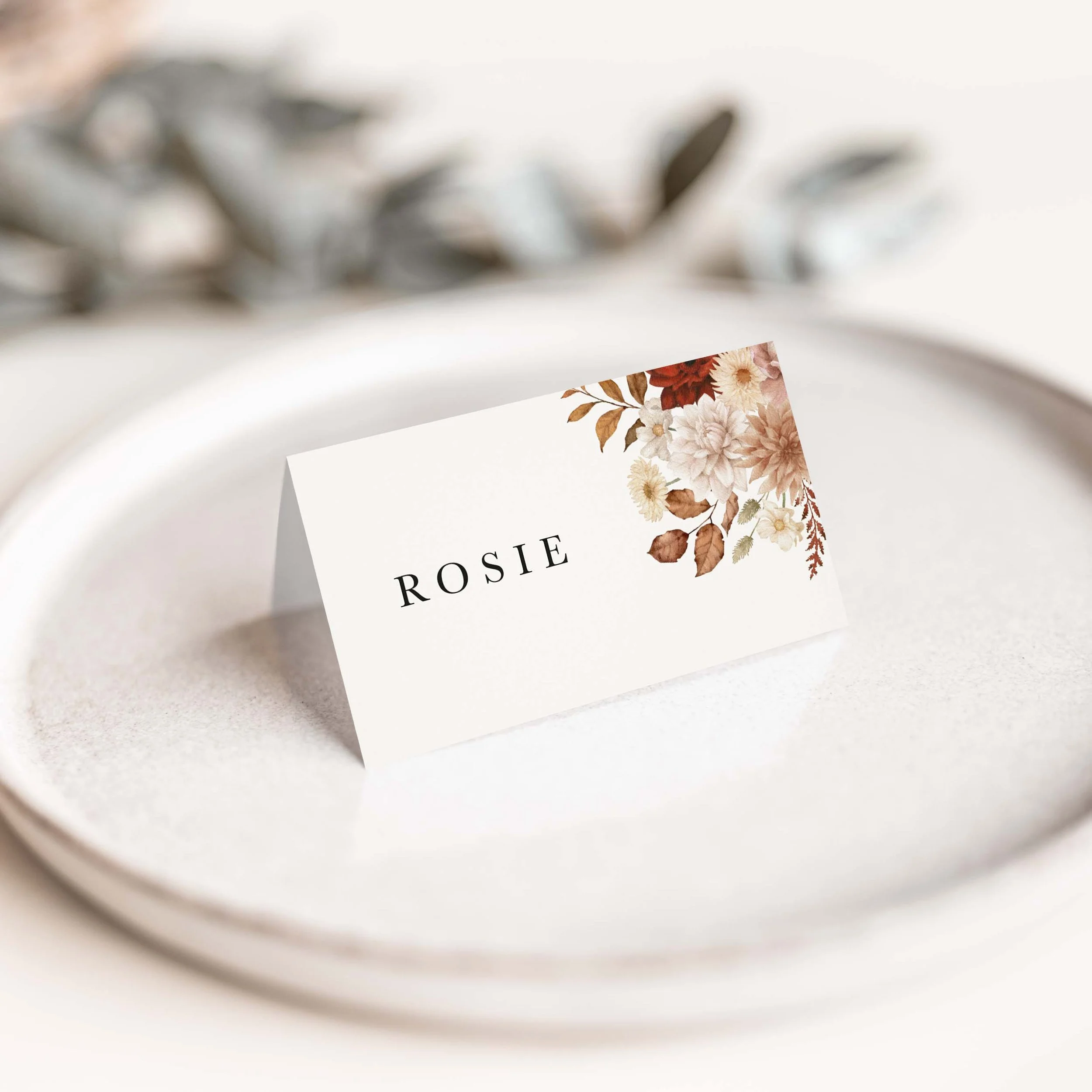 Rustic wedding place card with warm floral corner detail