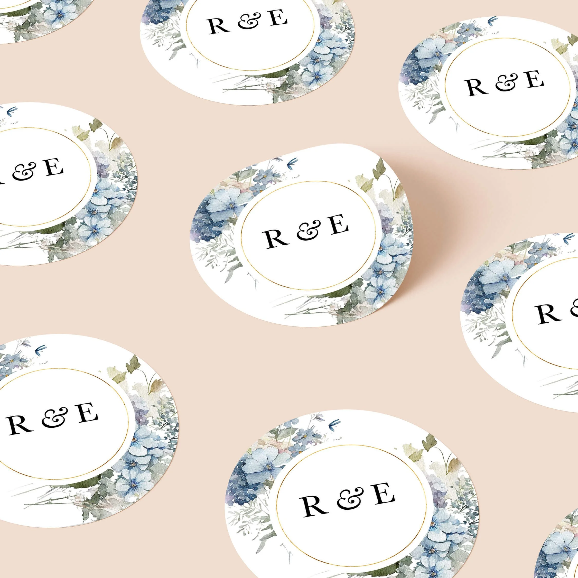 Dusty blue wedding stickers with blue floral design and initials repeated on personalised round seals