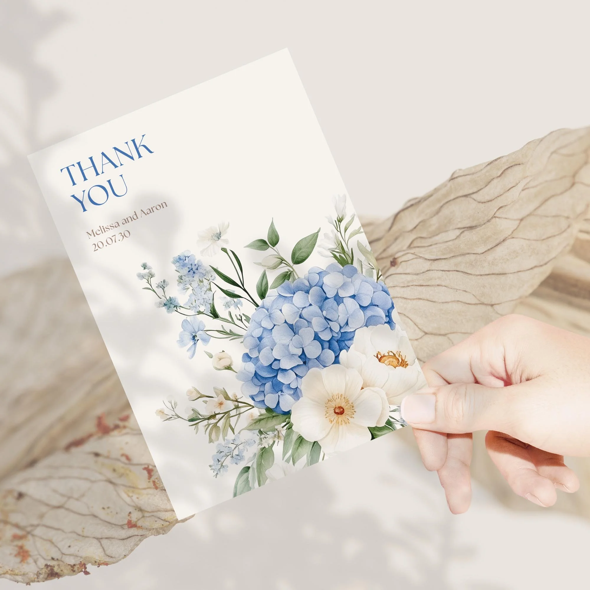 Person holding Serenity Wedding Thank You Card featuring blue corner floral design.