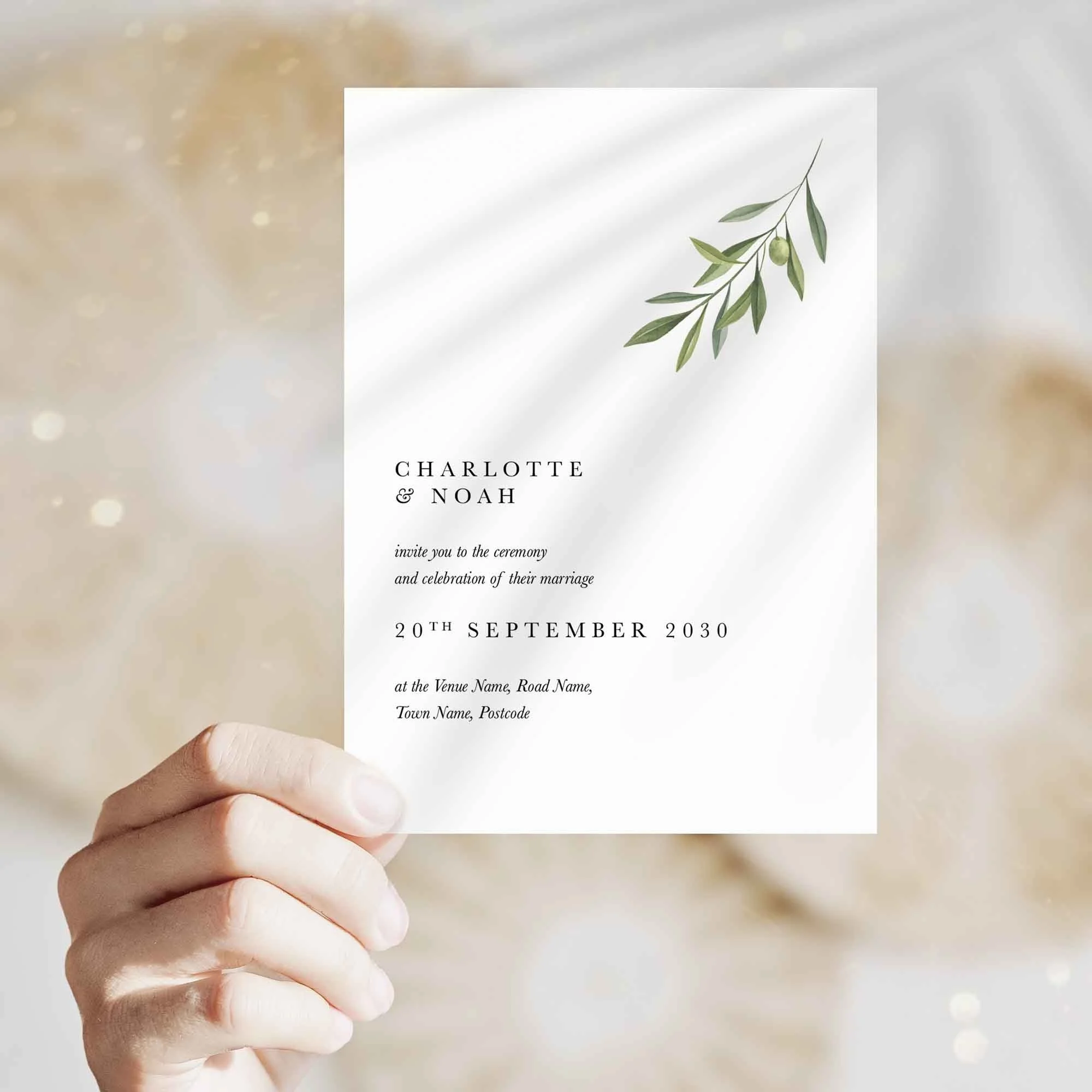 Hand holding Simple Olive Branch wedding invitation showing size and printed design details