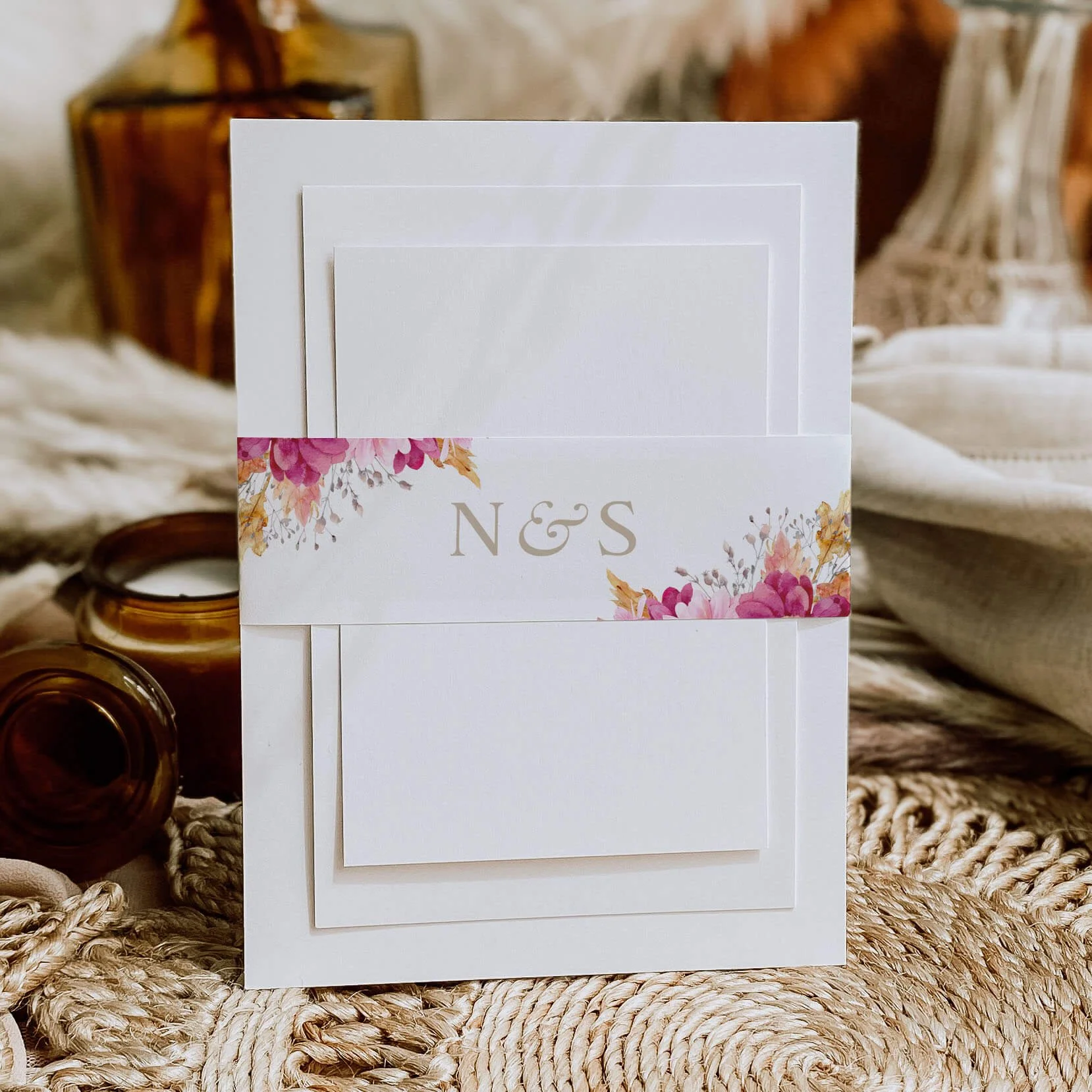 Chrysanthemum personalised wedding belly bands with bold magenta and orange floral watercolour illustration wrapped around wedding invitations
