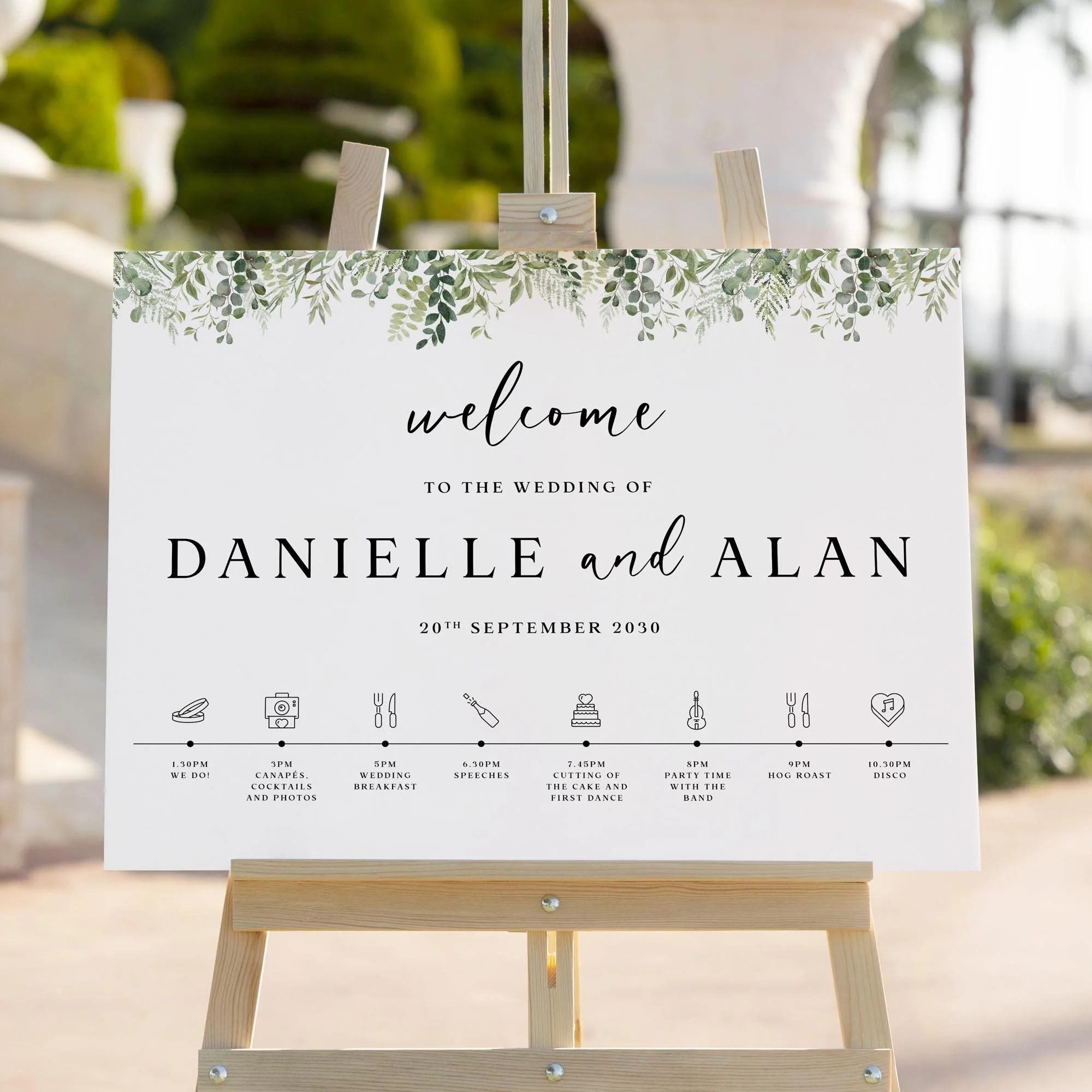 Greenery with Timeline of the Day wedding welcome sign styled outdoors close-up