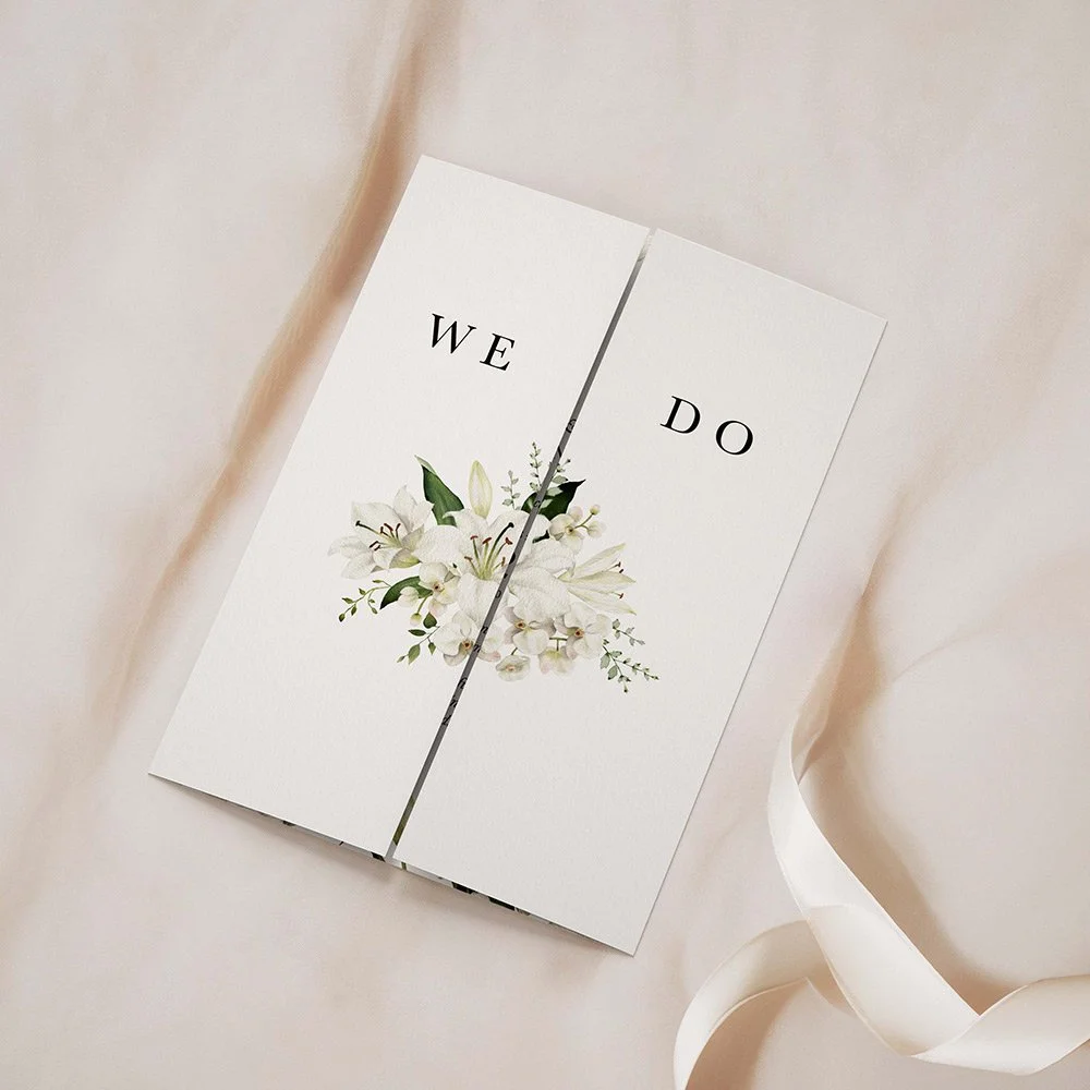 Garden Collection Wreath gatefold wedding invitation closed, featuring a wreath of greenery and white lilies with elegant typography.