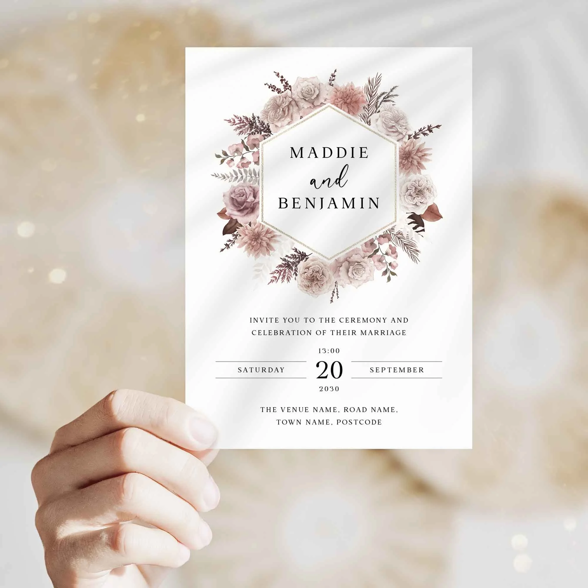 Hand holding Pink Boho Floral wedding invitation showing size and printed design details