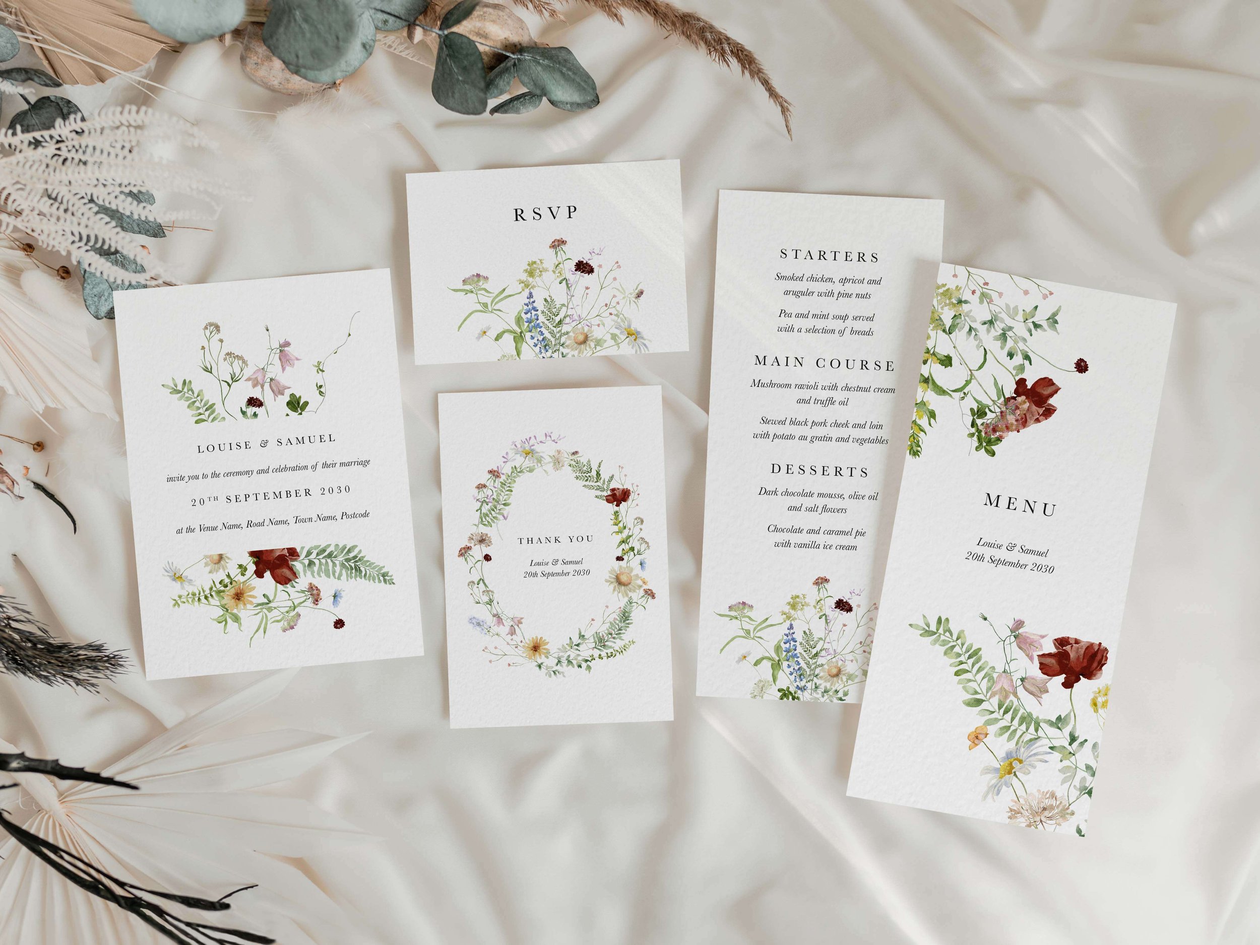 Full Meadow wedding stationery suite flat lay showing invitations, RSVP cards and coordinating pieces with rustic meadow wildflower design