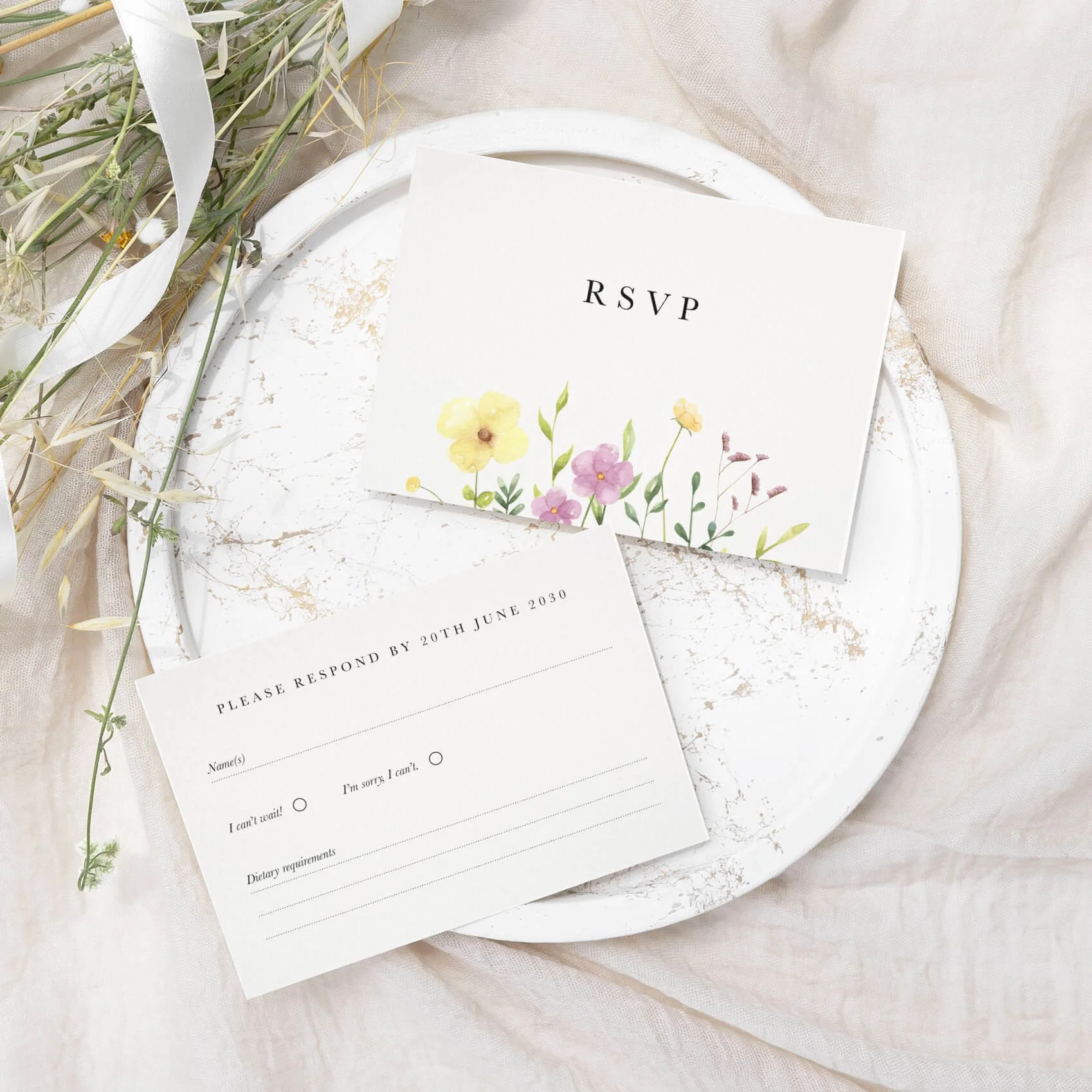 Wildflower wedding RSVP card with scattered yellow and pink watercolour meadow bloom illustration on luxury off-white card