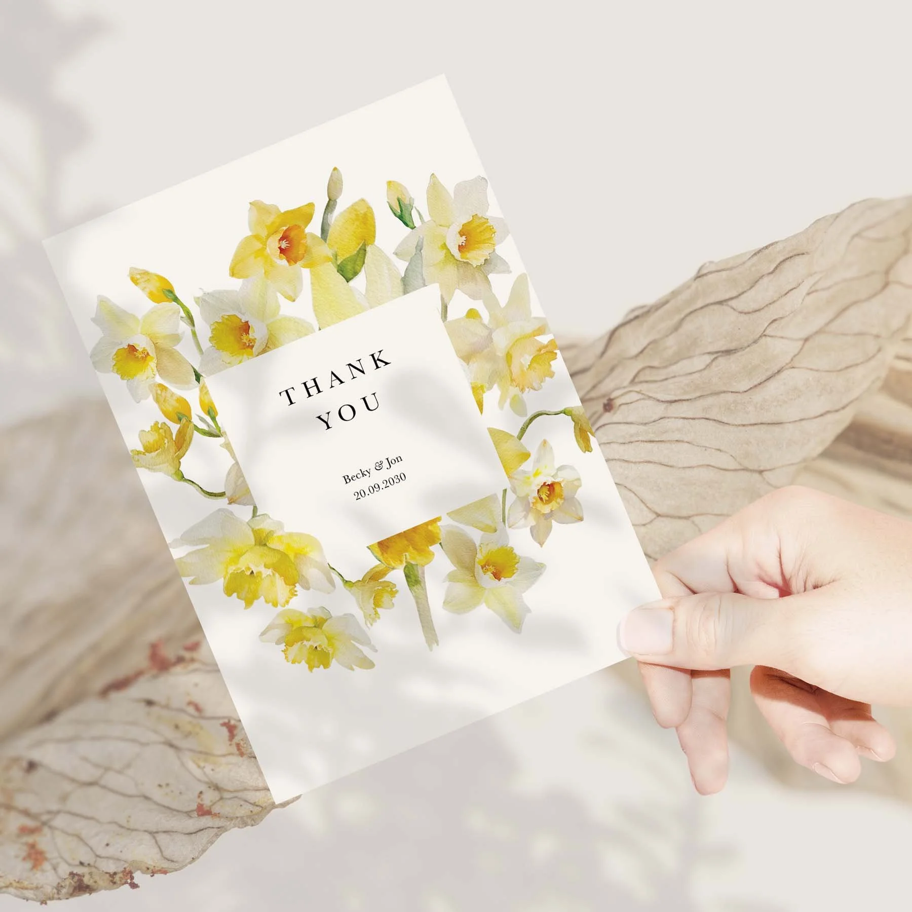 Hand holding a Daffodil wedding thank you card