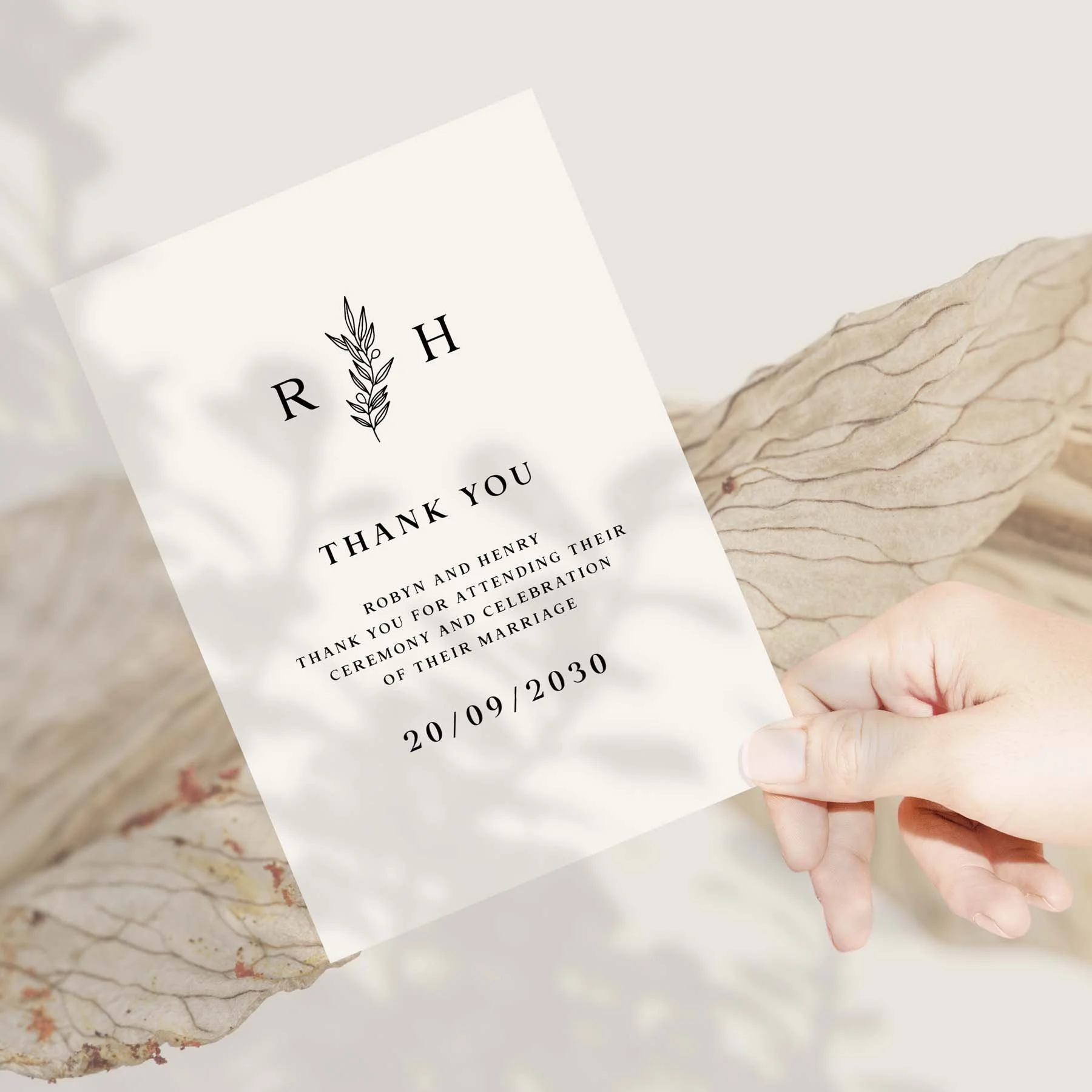 Hand holding a Black and White wedding thank you card