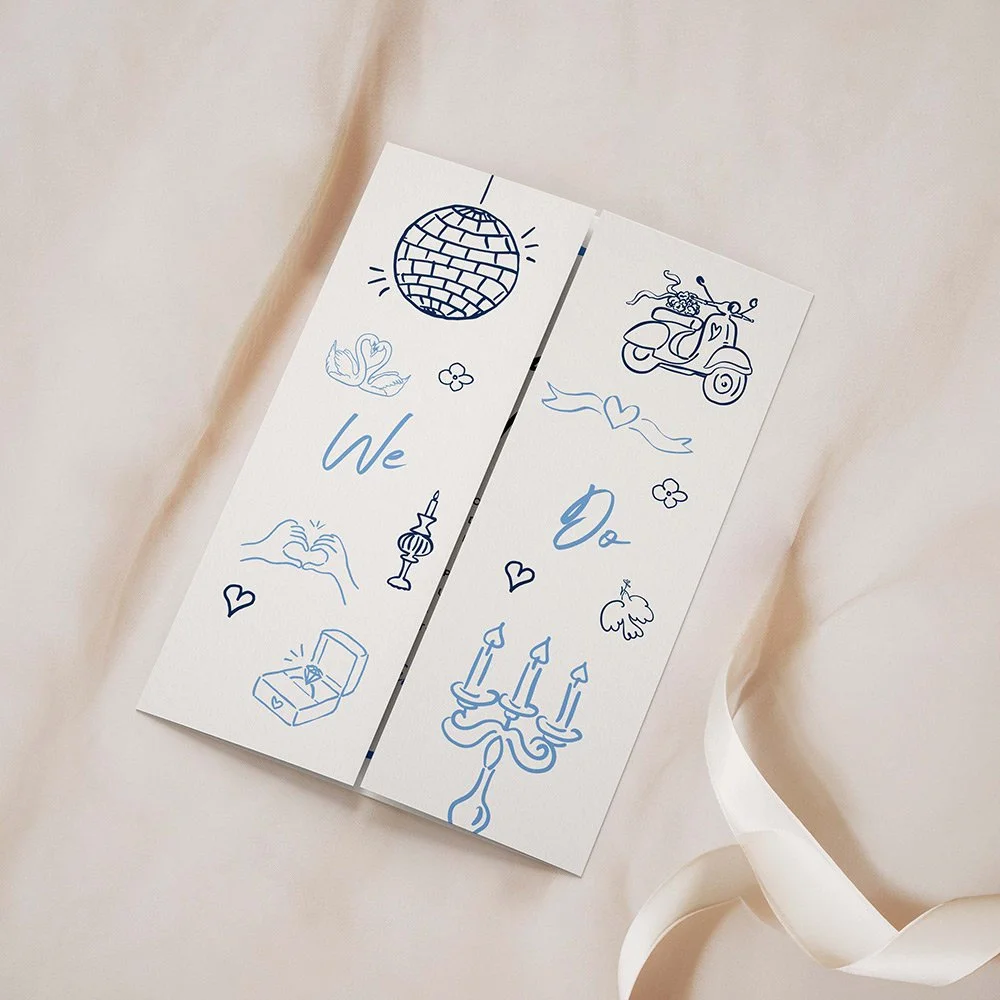 Blue gatefold wedding invitation with modern whimsical line-drawn illustrations and handwritten-style font