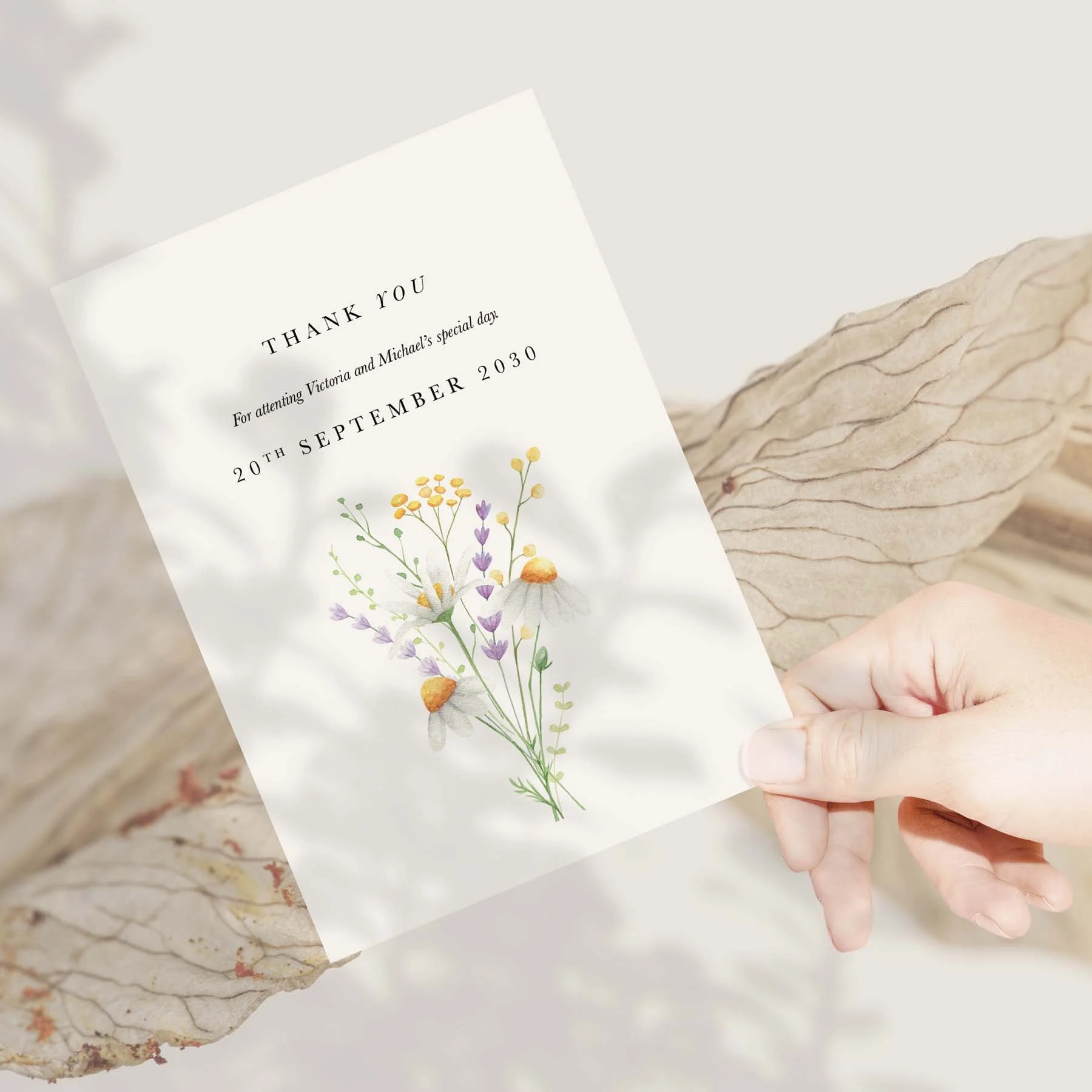 Hand holding a Daisy wedding thank you card