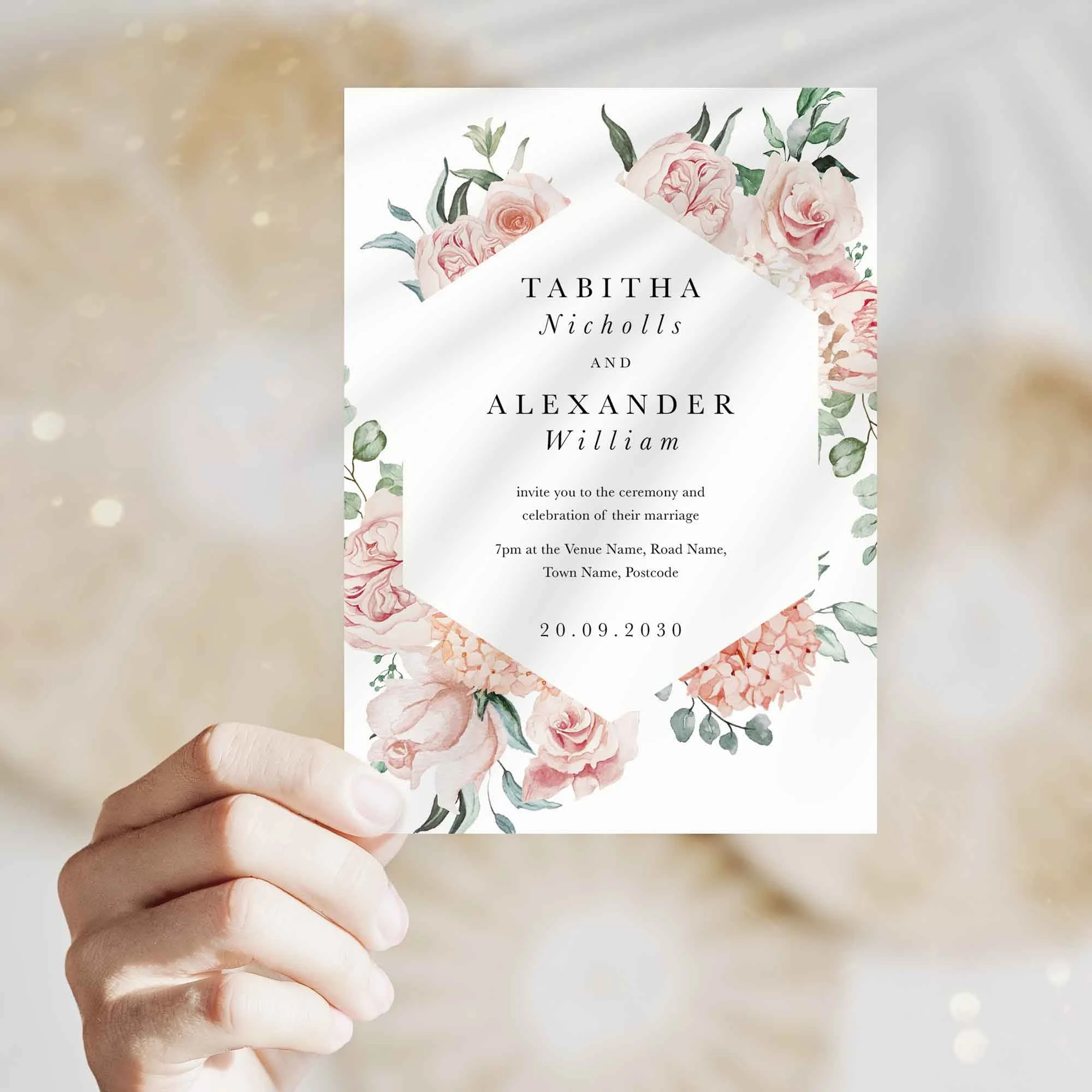 Hand holding Blush Pink Peony wedding invitation showing size and printed design details
