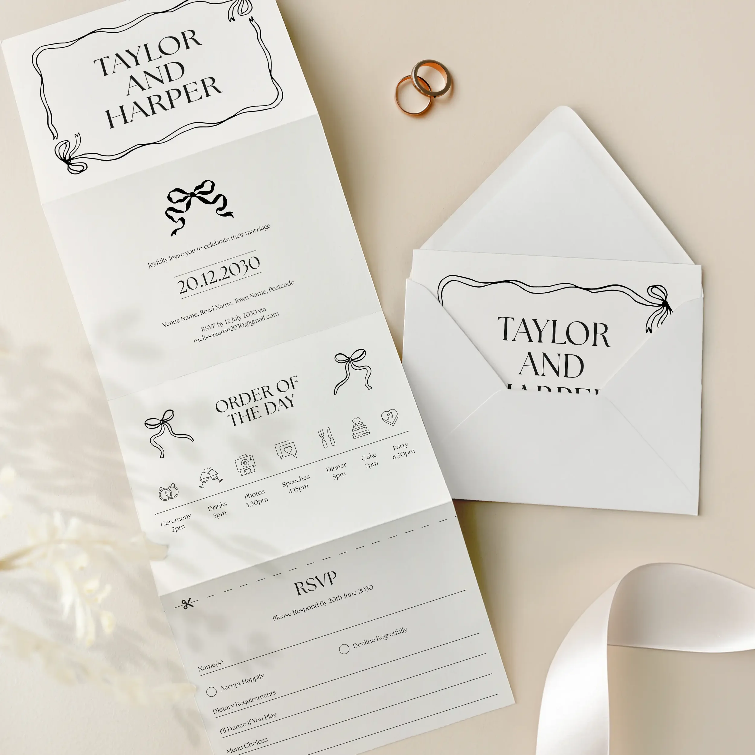 Flat lay of Black Tie Concertina Wedding Invitation with black bow detail.