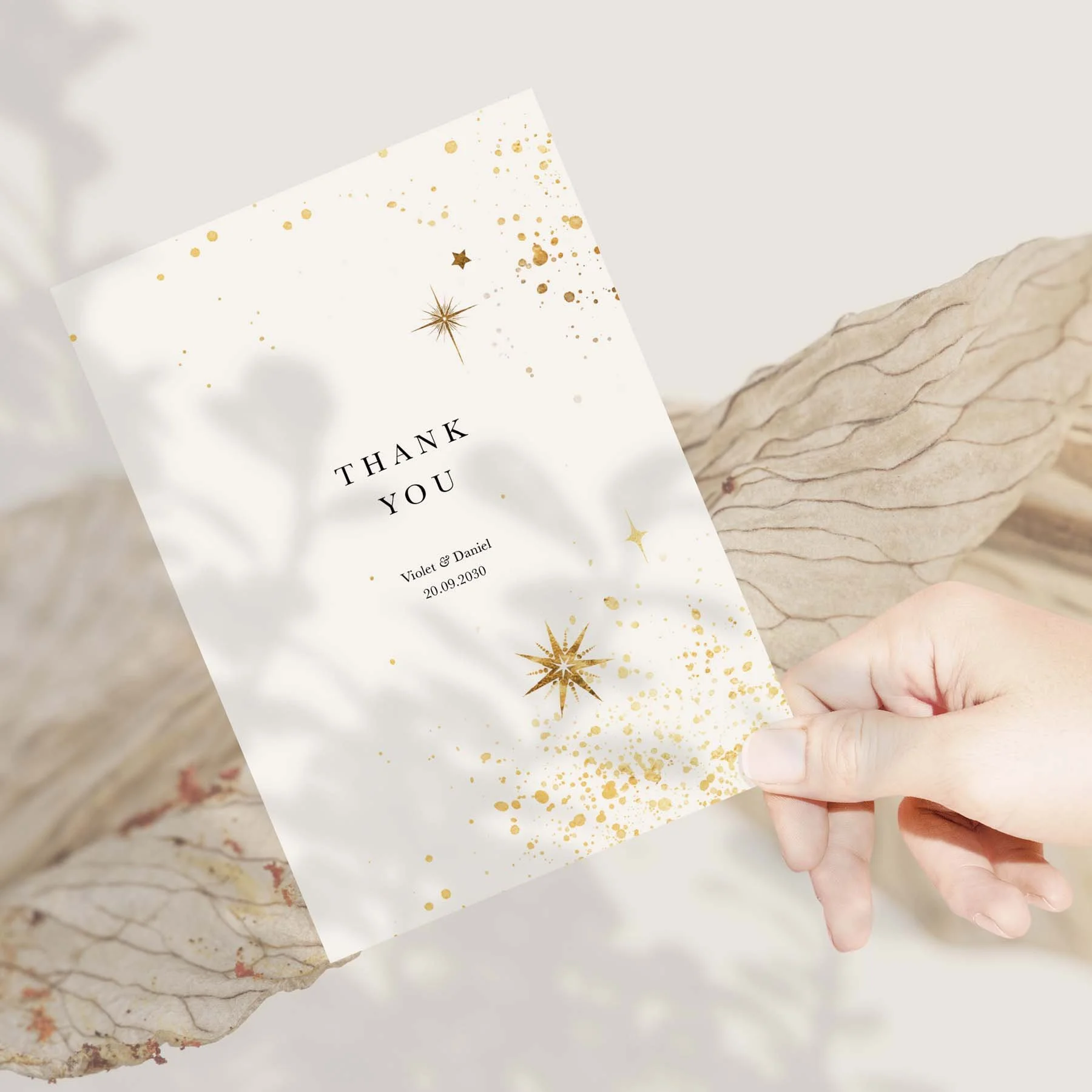 Hand holding a Celestial Gold Star wedding thank you card