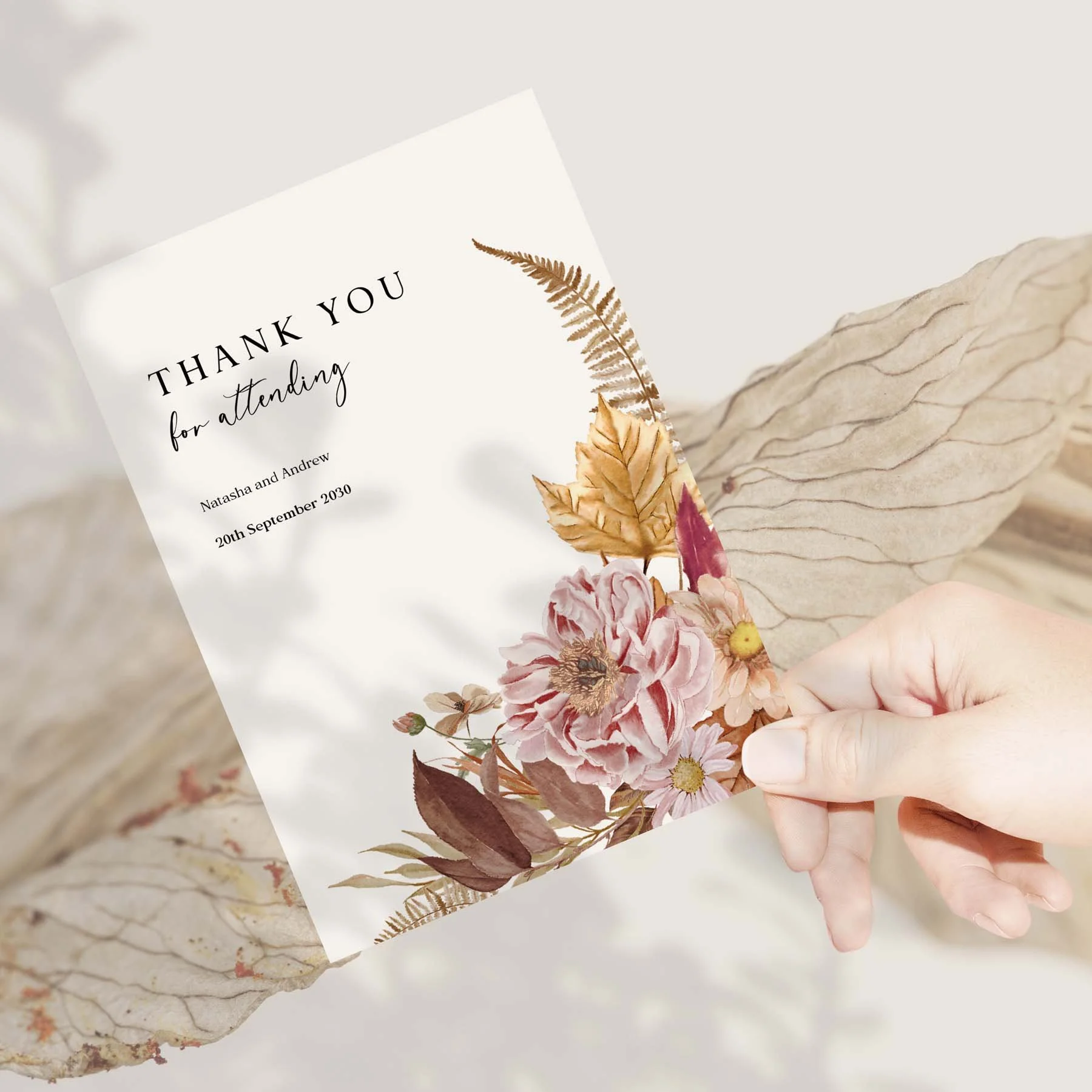 Hand holding an Autumn wedding thank you card
