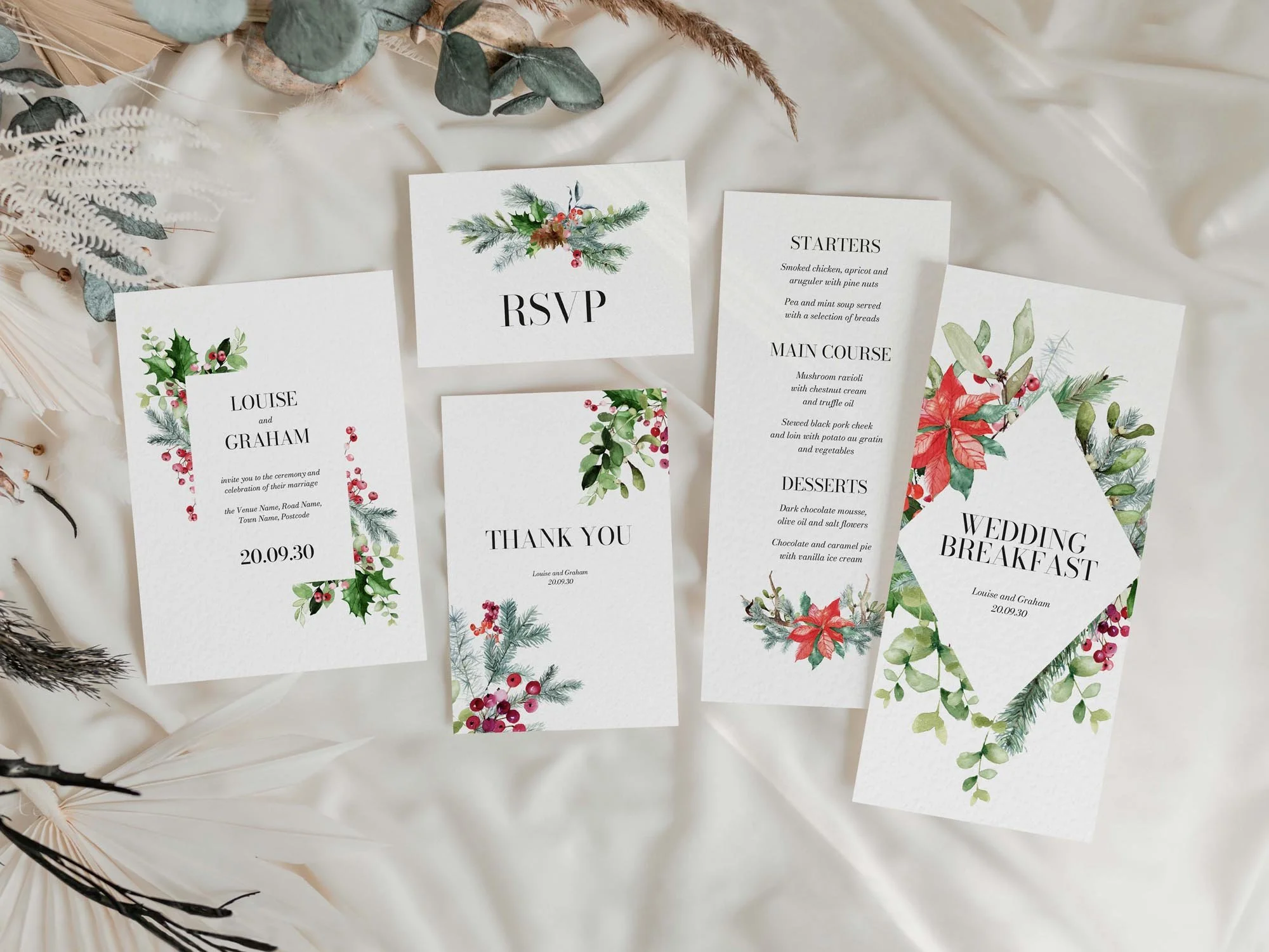 Winter wedding invitations featuring green foliage and red berries