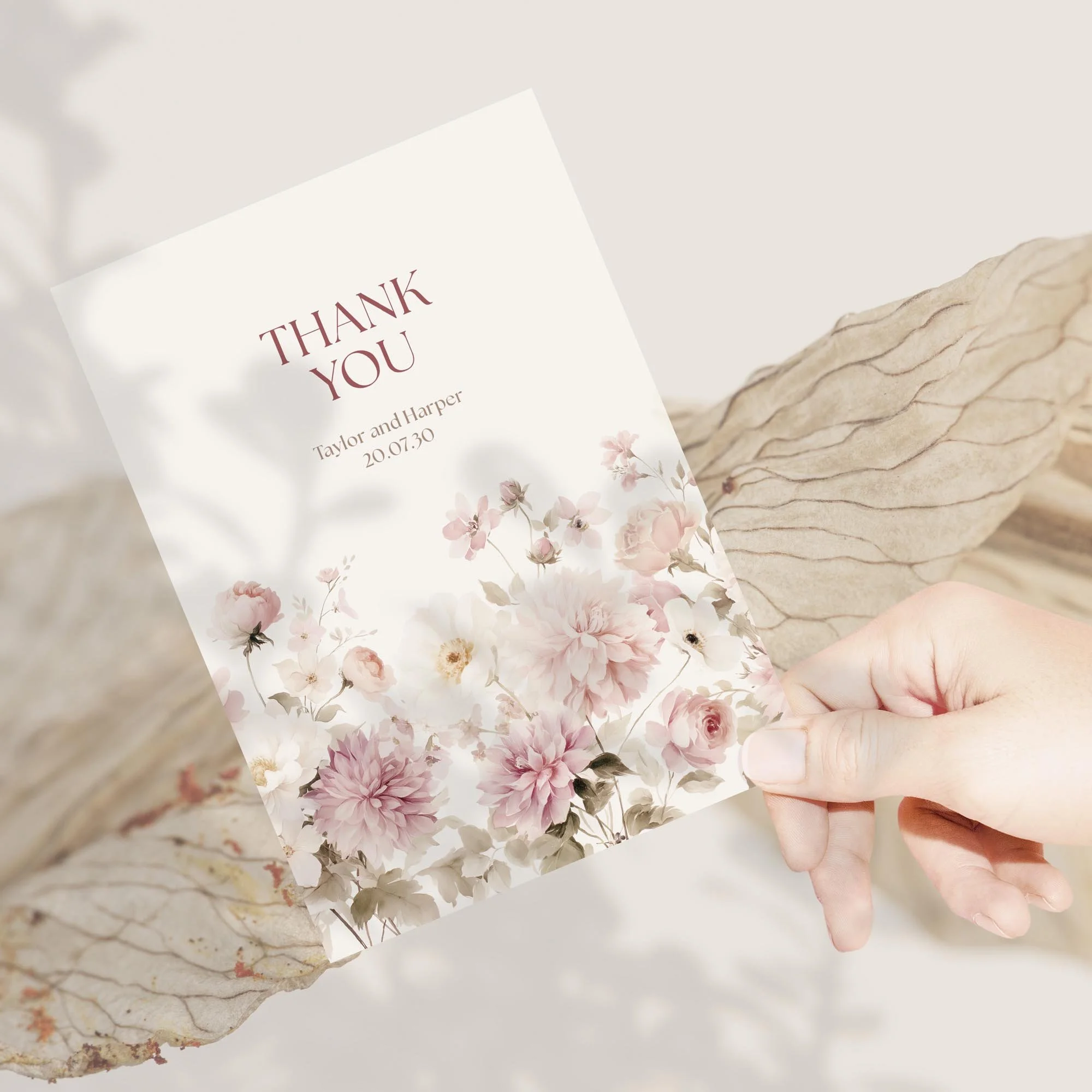Hand holding a floral wedding thank you card with pink dahlia and wildflower design from Wonder Wedding Stationery