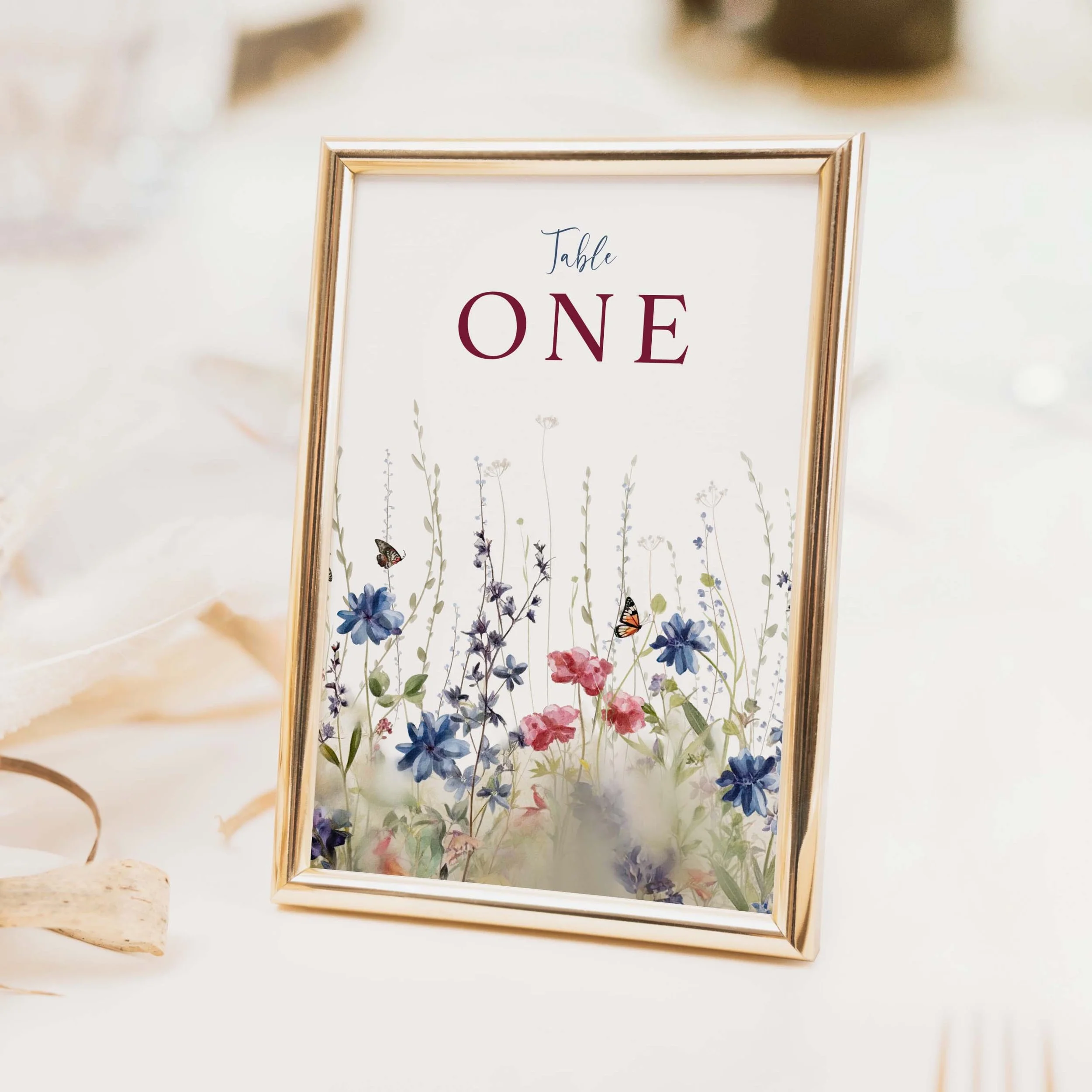 Field Navy wedding table number with deep navy blue wildflower botanical illustration and elegant typography on luxury off-white card