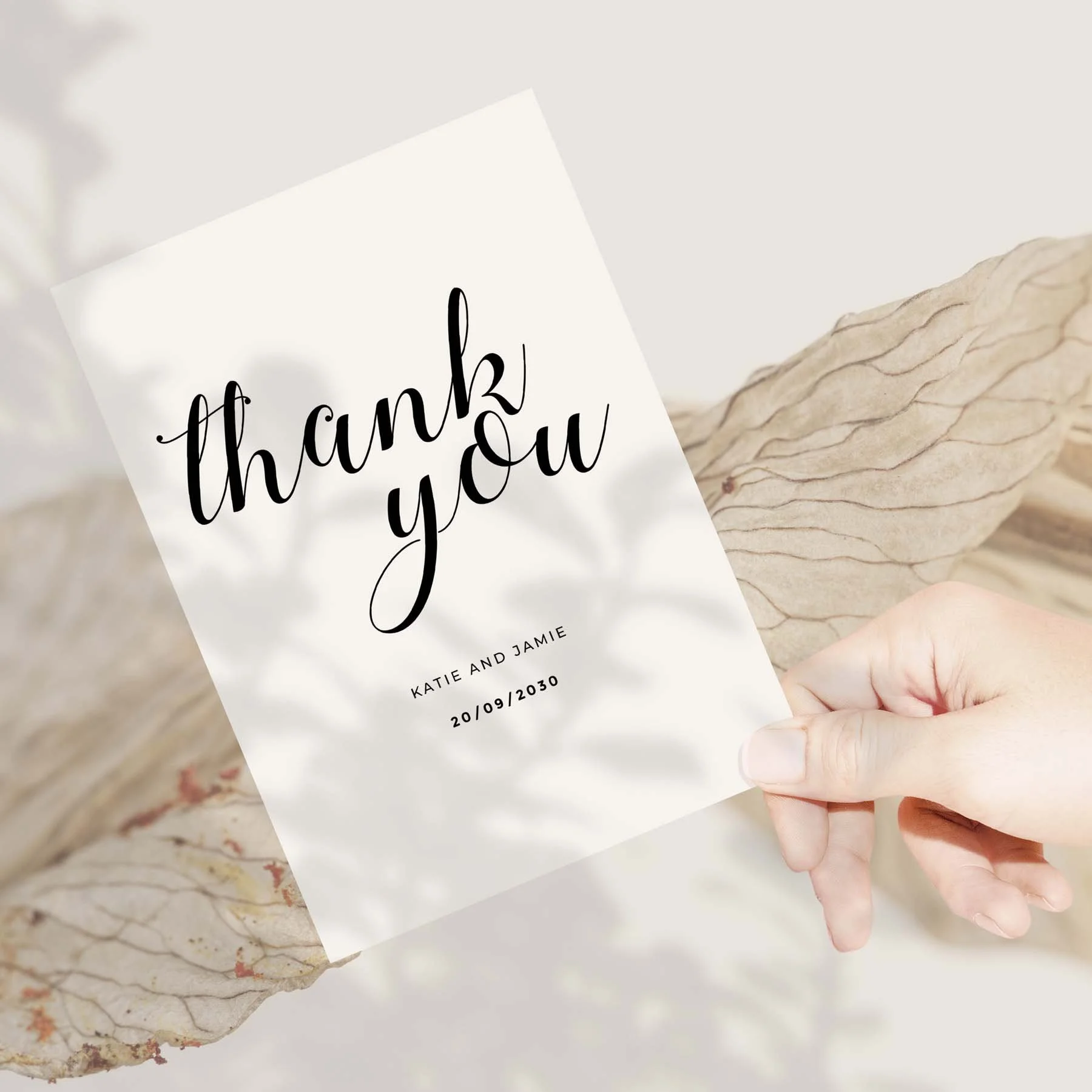 Hand holding a Calligraphy Font wedding thank you card