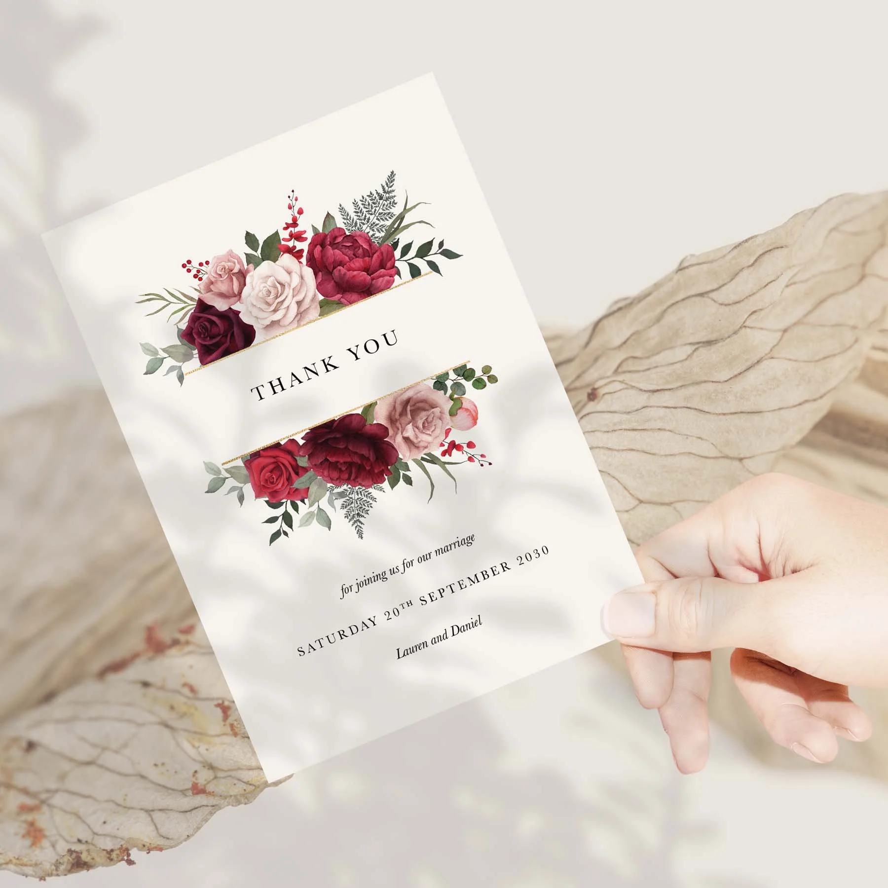 Hand holding a Burgundy Floral wedding thank you card