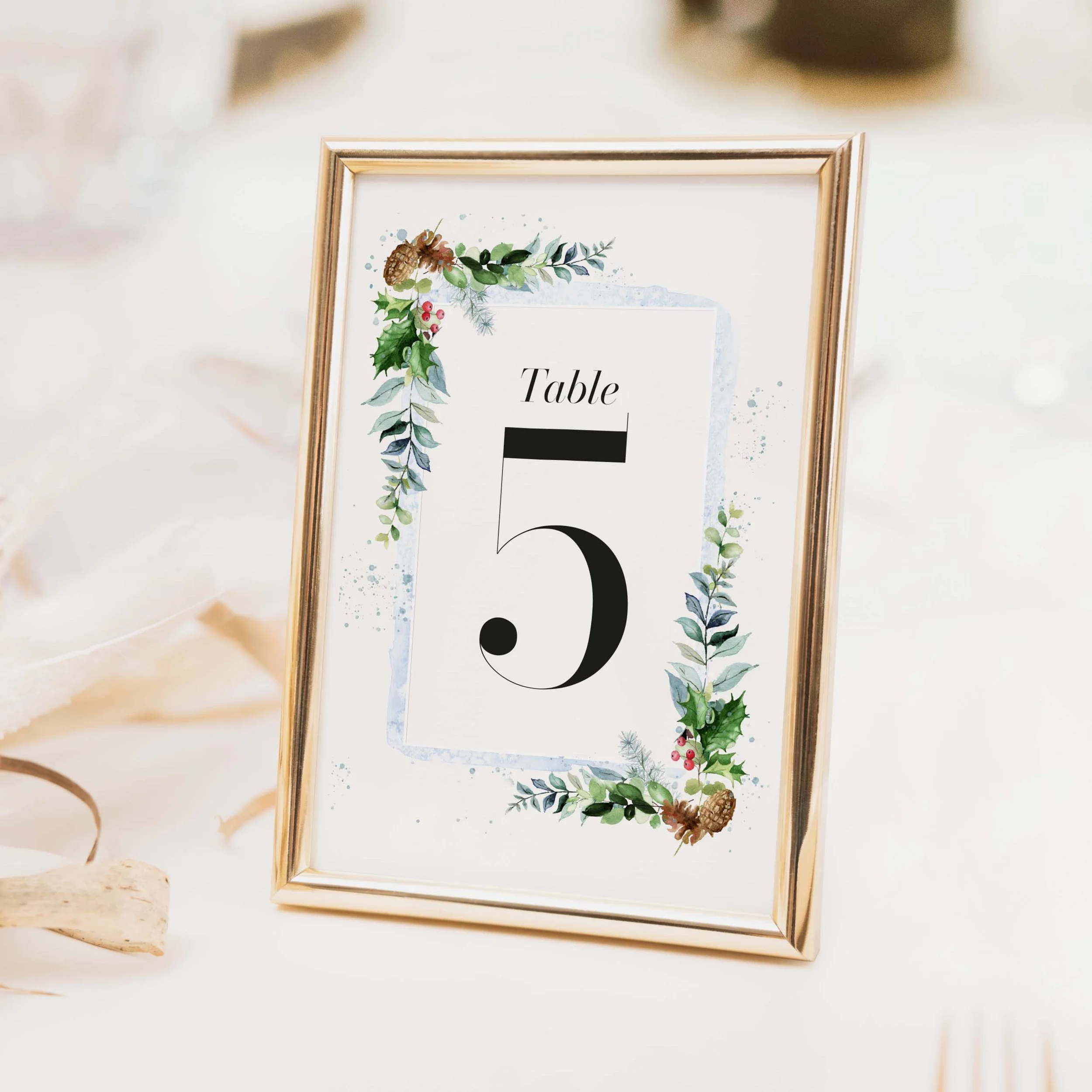 Festive wedding table number with Christmas botanical illustration and classic typography on luxury off-white card