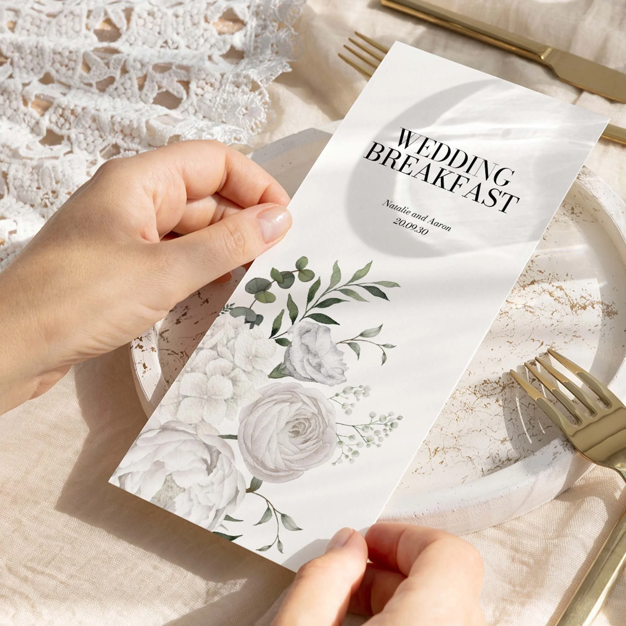 Hand holding White Floral wedding menu card showing size and printed design details