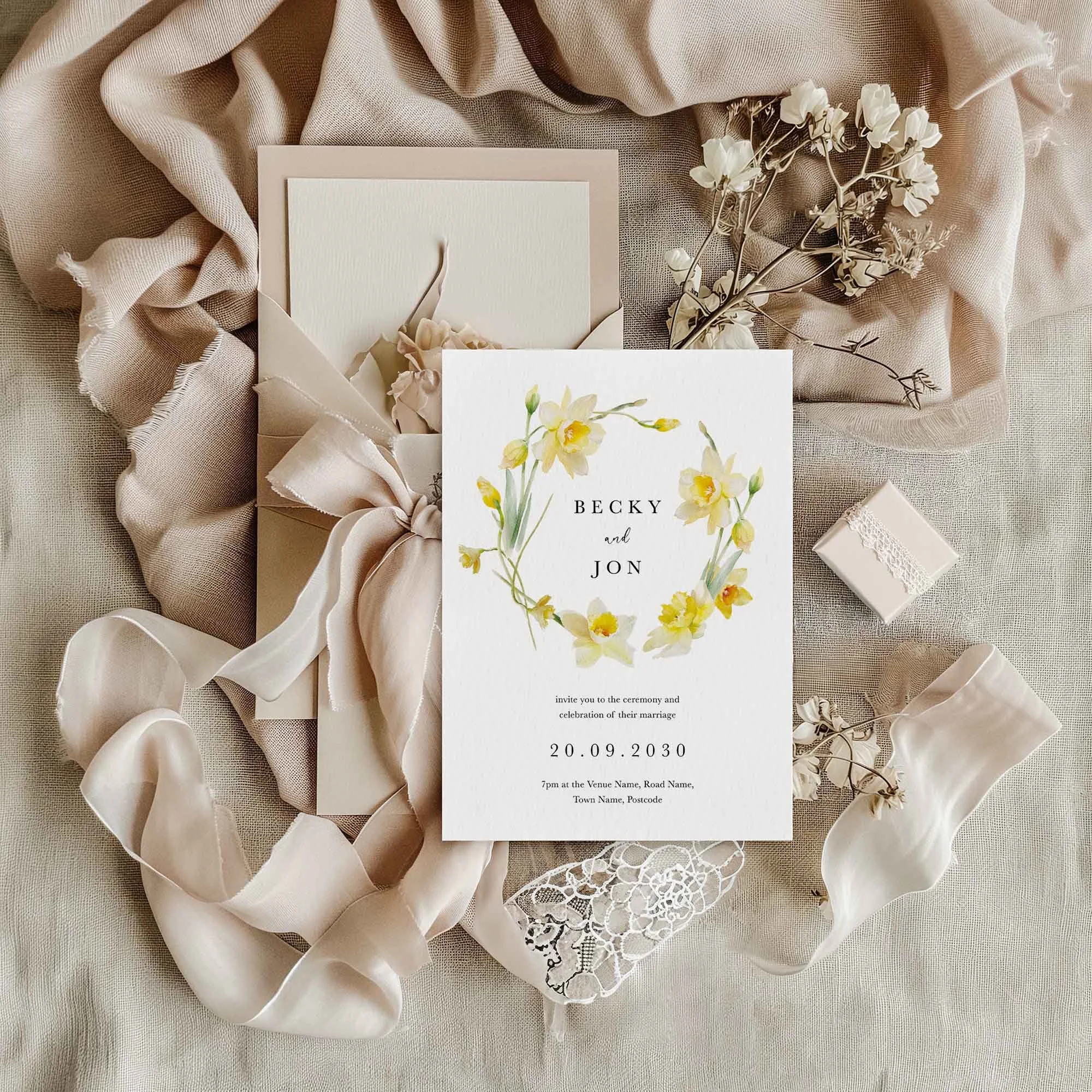 Daffodil Wreath wedding invitation styled in a flat lay environment with wedding props