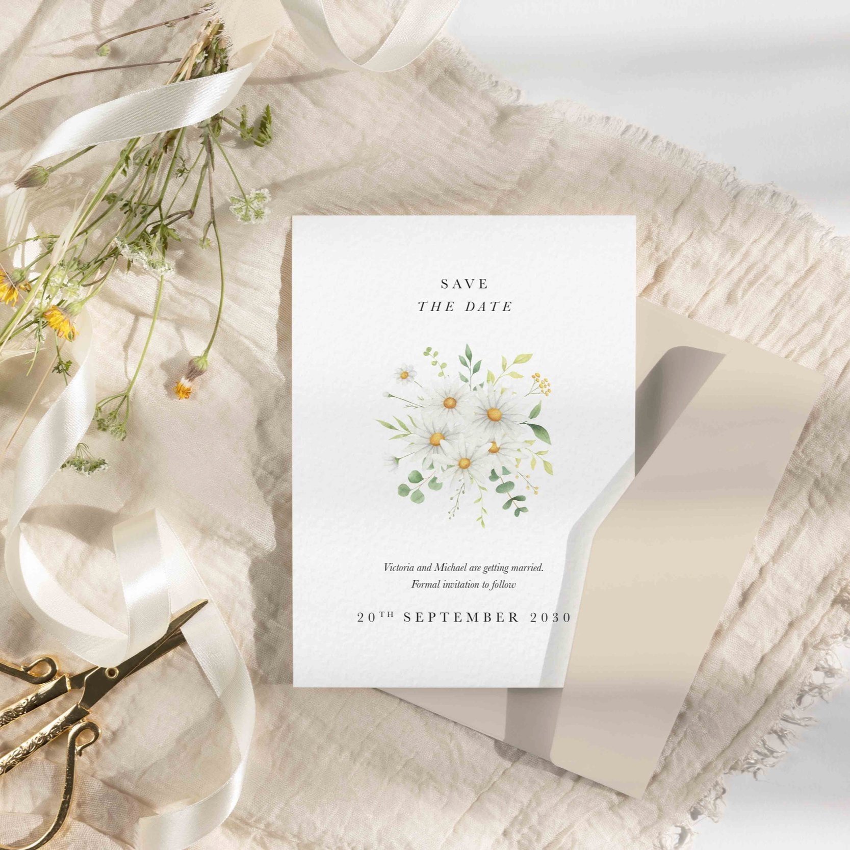 Wedding save the date card with soft white daisy illustrations and modern typography—perfect for a floral spring or summer wedding theme.