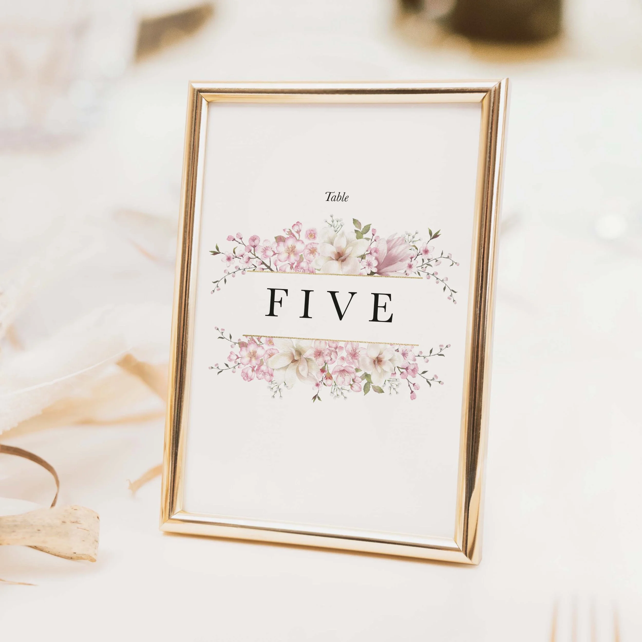 Cherry Blossom wedding table number with soft blush pink cherry blossom sprig illustration and flowing script typography printed on luxury off-white textured card