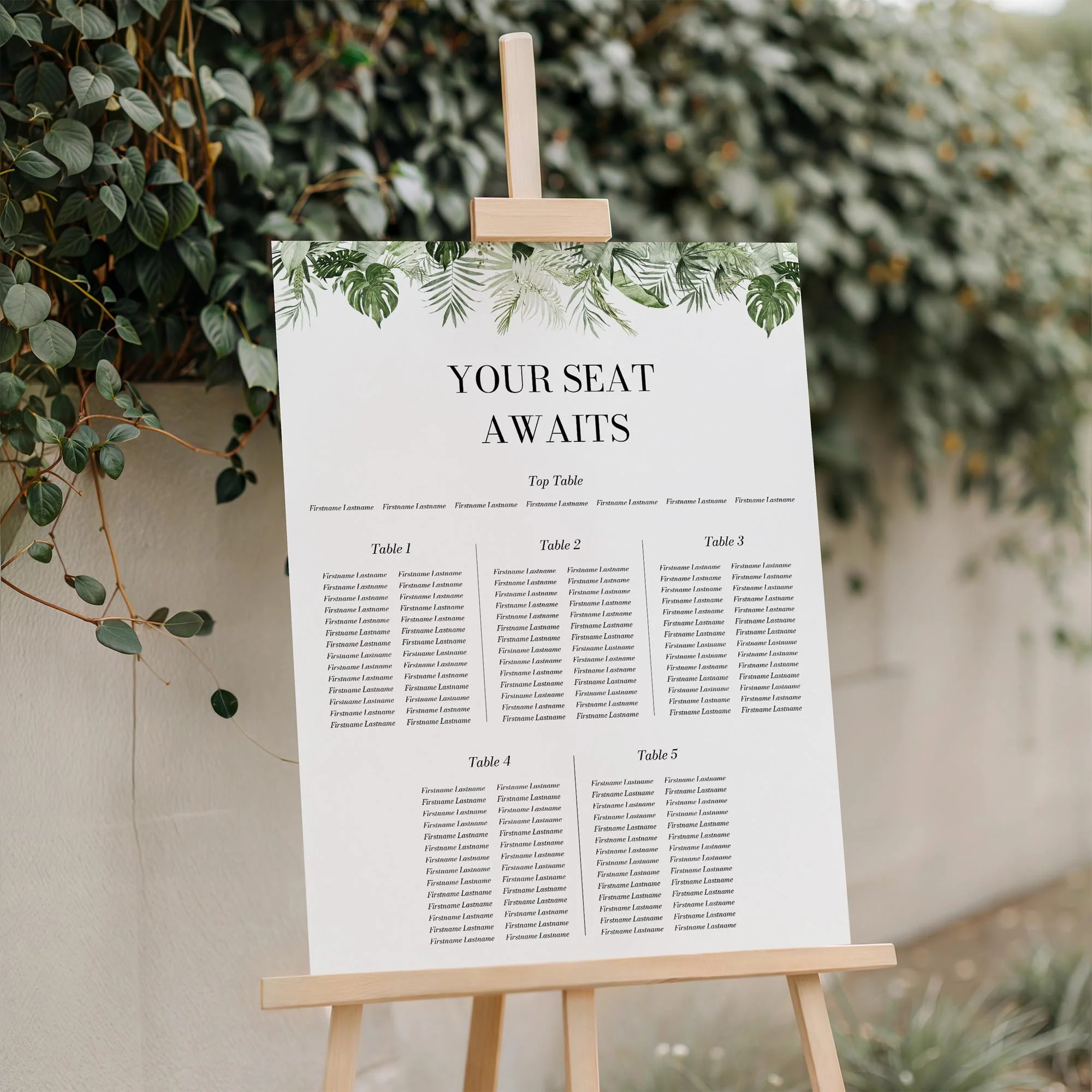 Close-up of the Tropical Leaves wedding seating plan board displayed outdoors