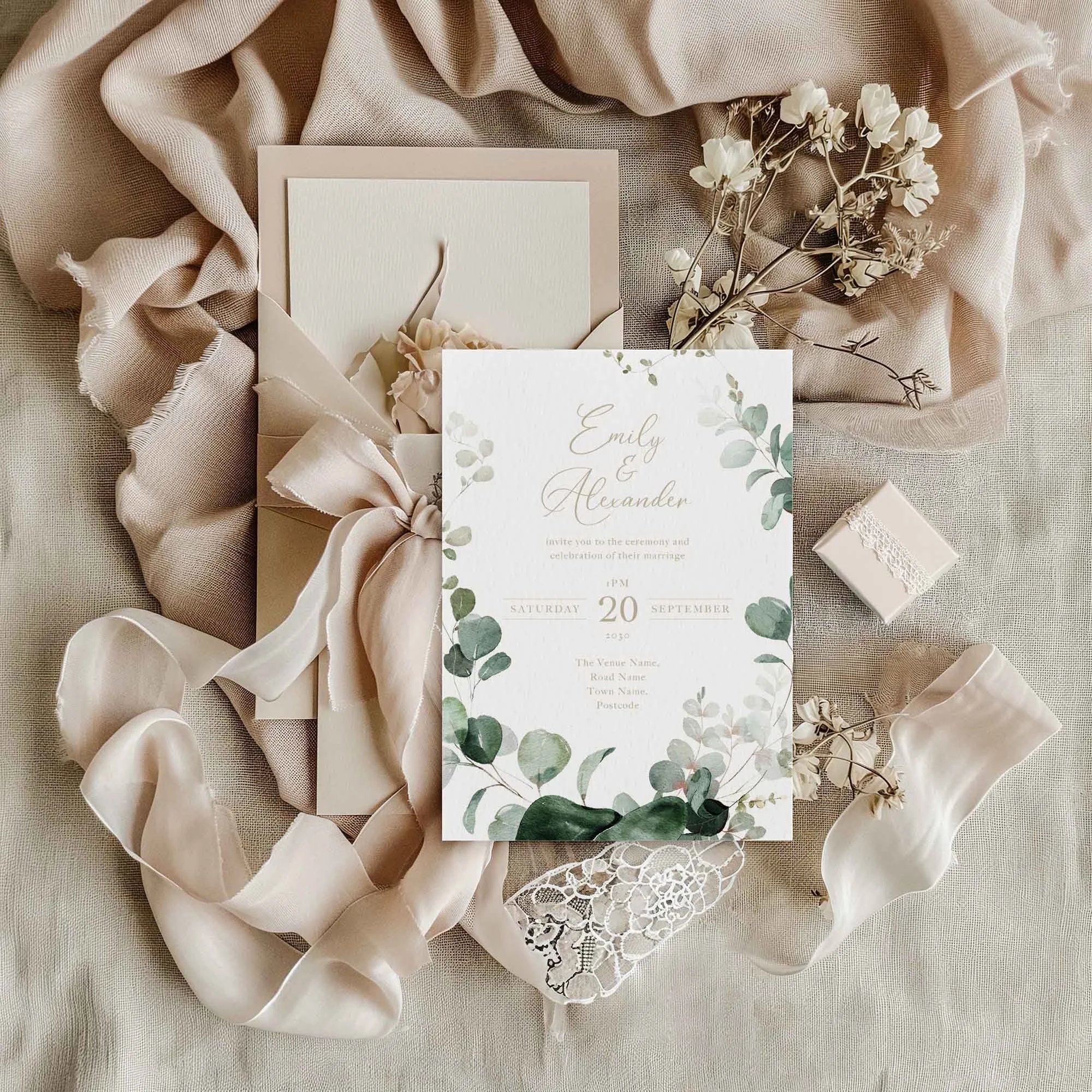 Emerald Forest Foliage wedding invitation styled in a flat lay environment with wedding props