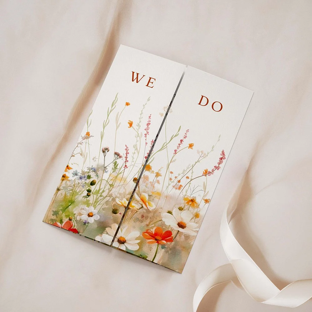 Field Collection Vermilion gatefold wedding invitation closed, featuring bold vermilion wildflowers with rustic greenery and elegant serif fonts