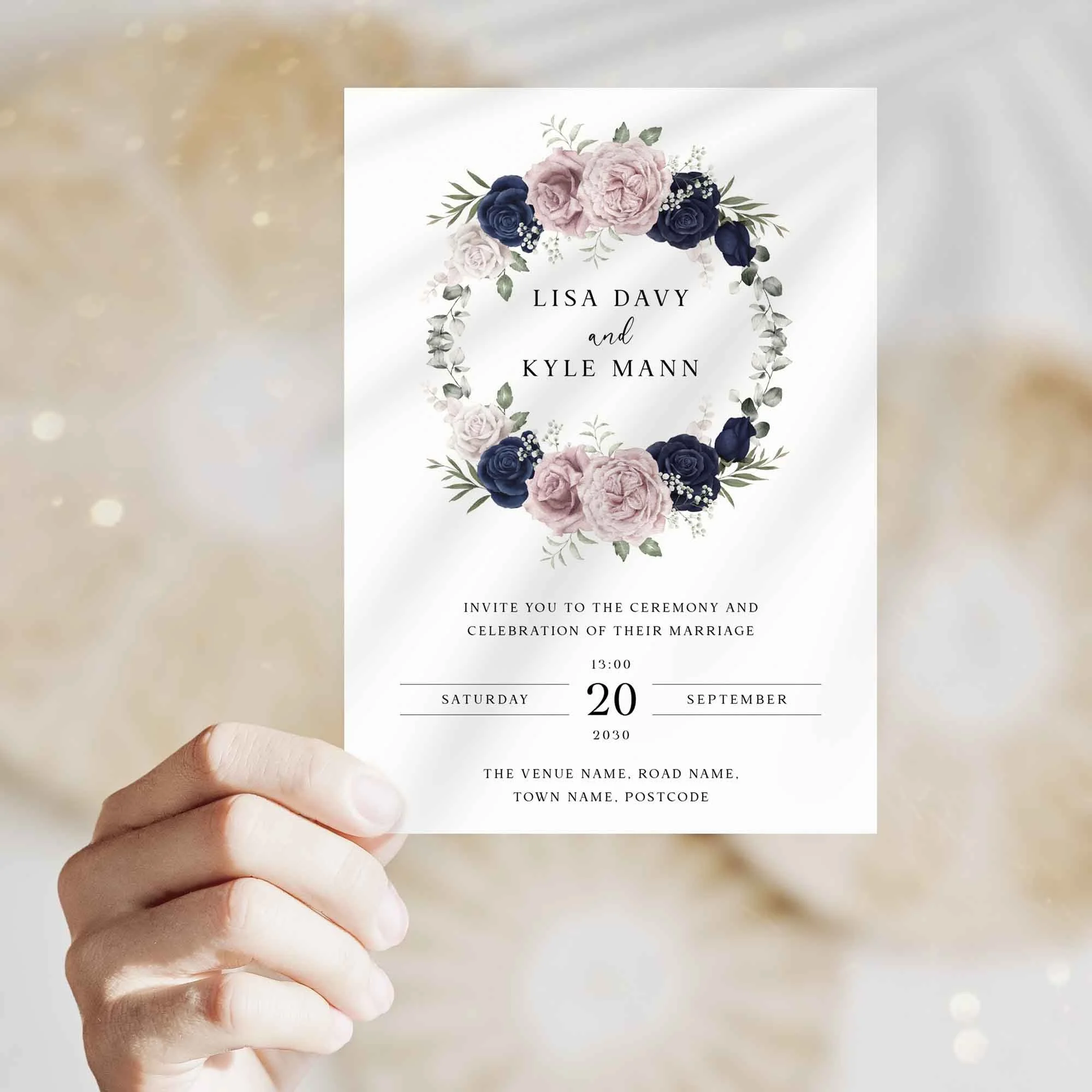 Hand holding Blue and Pink Wreath wedding invitation showing size and printed design details