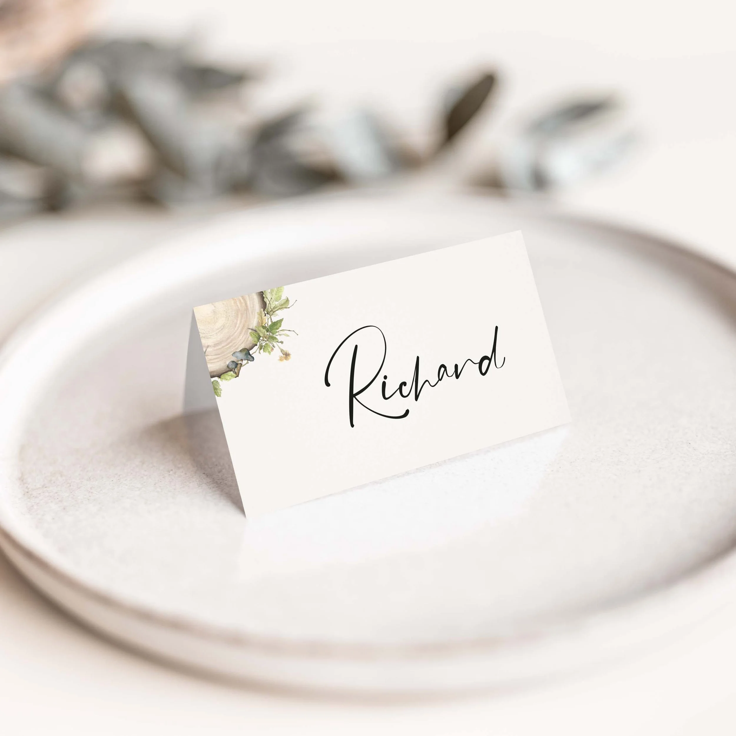 Wood Slice wedding place card with illustrated wood slice tree ring and flowing calligraphy script guest name on luxury off-white card