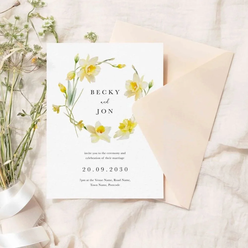 Daffodil Collection wedding stationery with a circular floral wreath of yellow daffodils in watercolour style framing names with fresh, bright spring theme