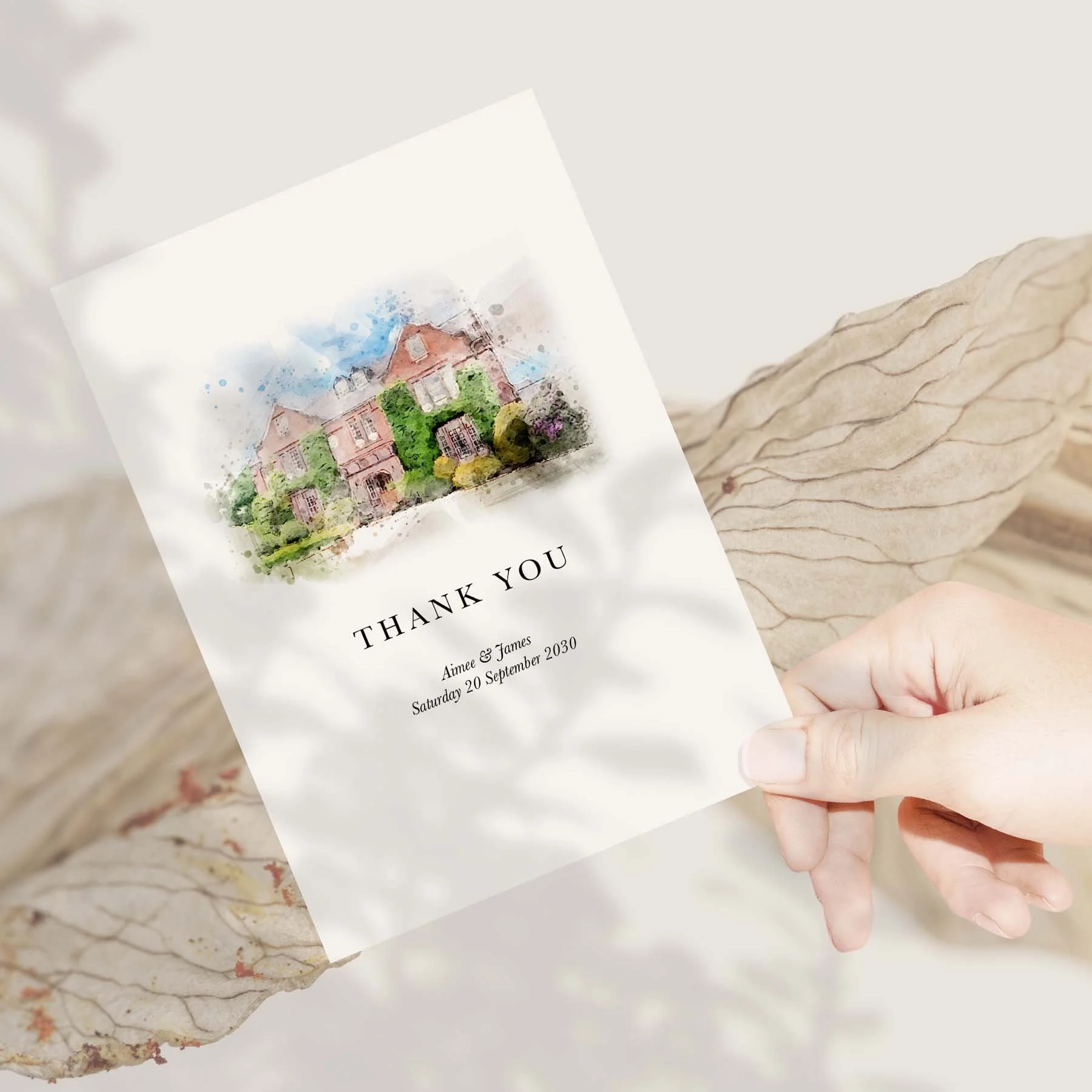 Hand holding a Bespoke Watercolour Venue Illustration wedding thank you card