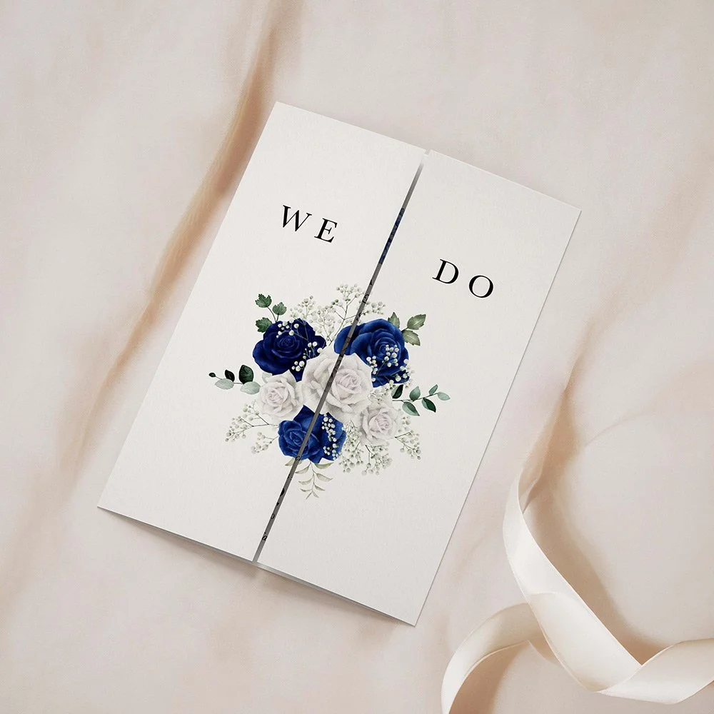 Royal Collection Bouquet gatefold wedding invitation closed, featuring a blue-toned floral bouquet with sage green leaves at the top centre.