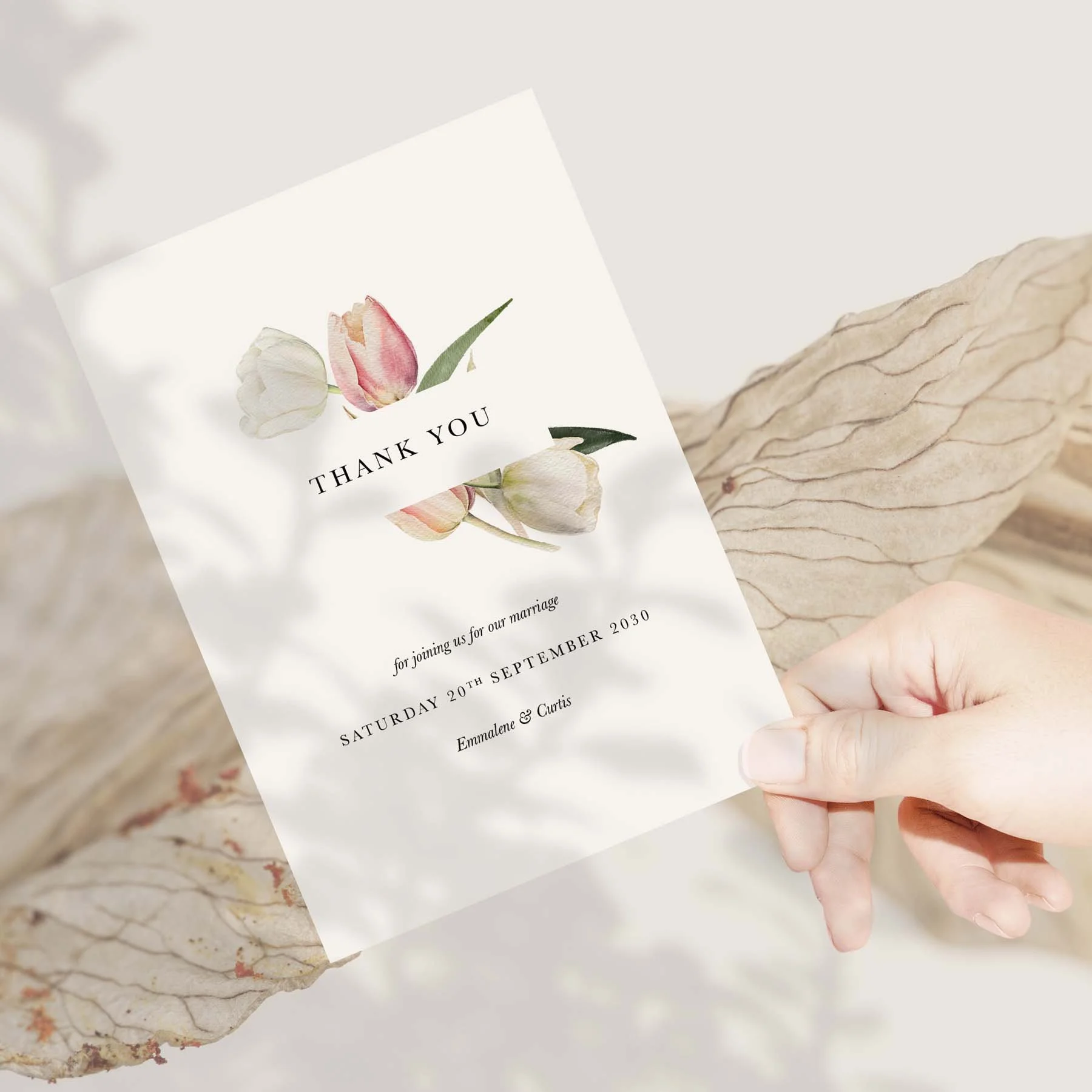 Hand holding a Tulip wedding thank you card