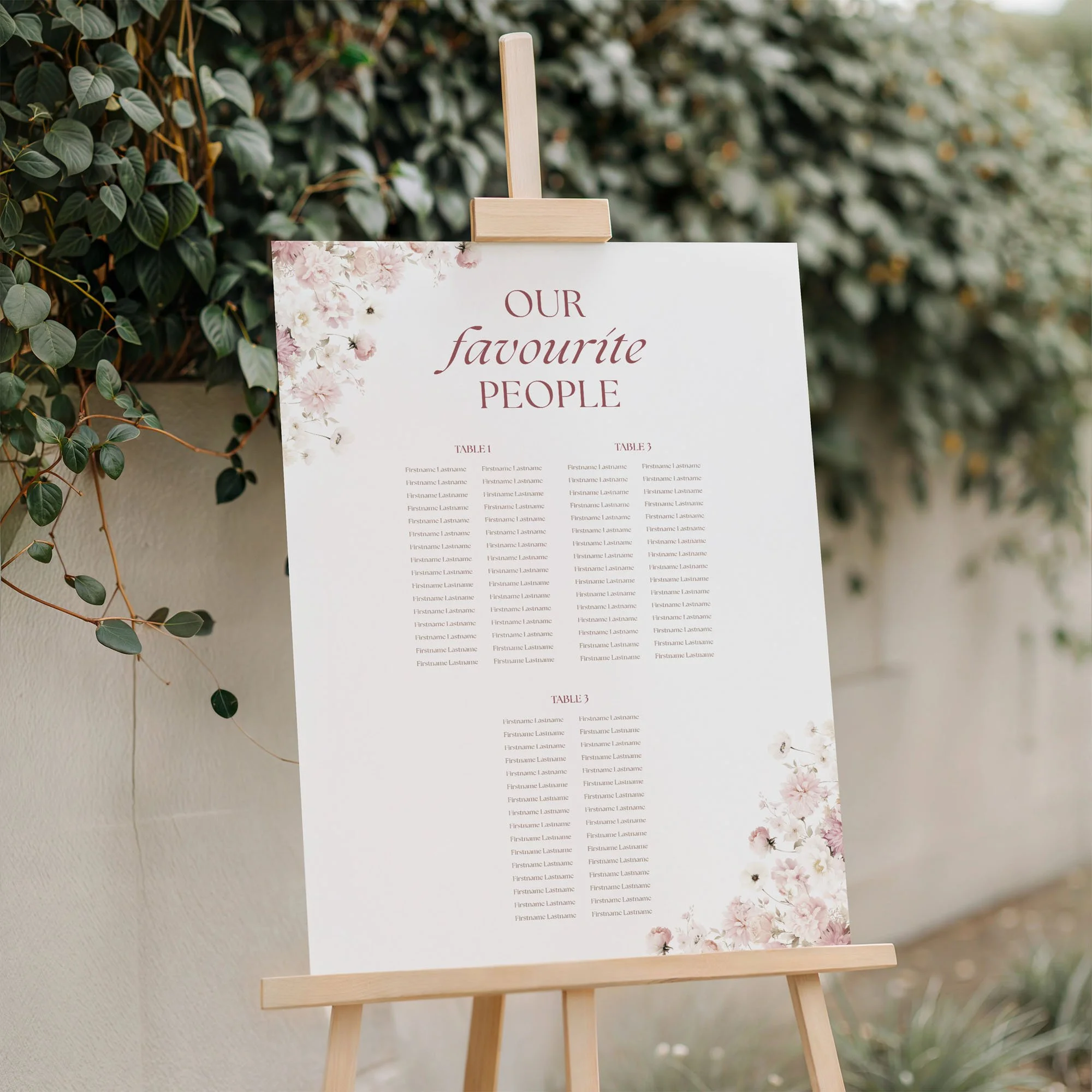 Petal Wedding Table Plan Board displayed on an easel at a wedding venue with floral details.