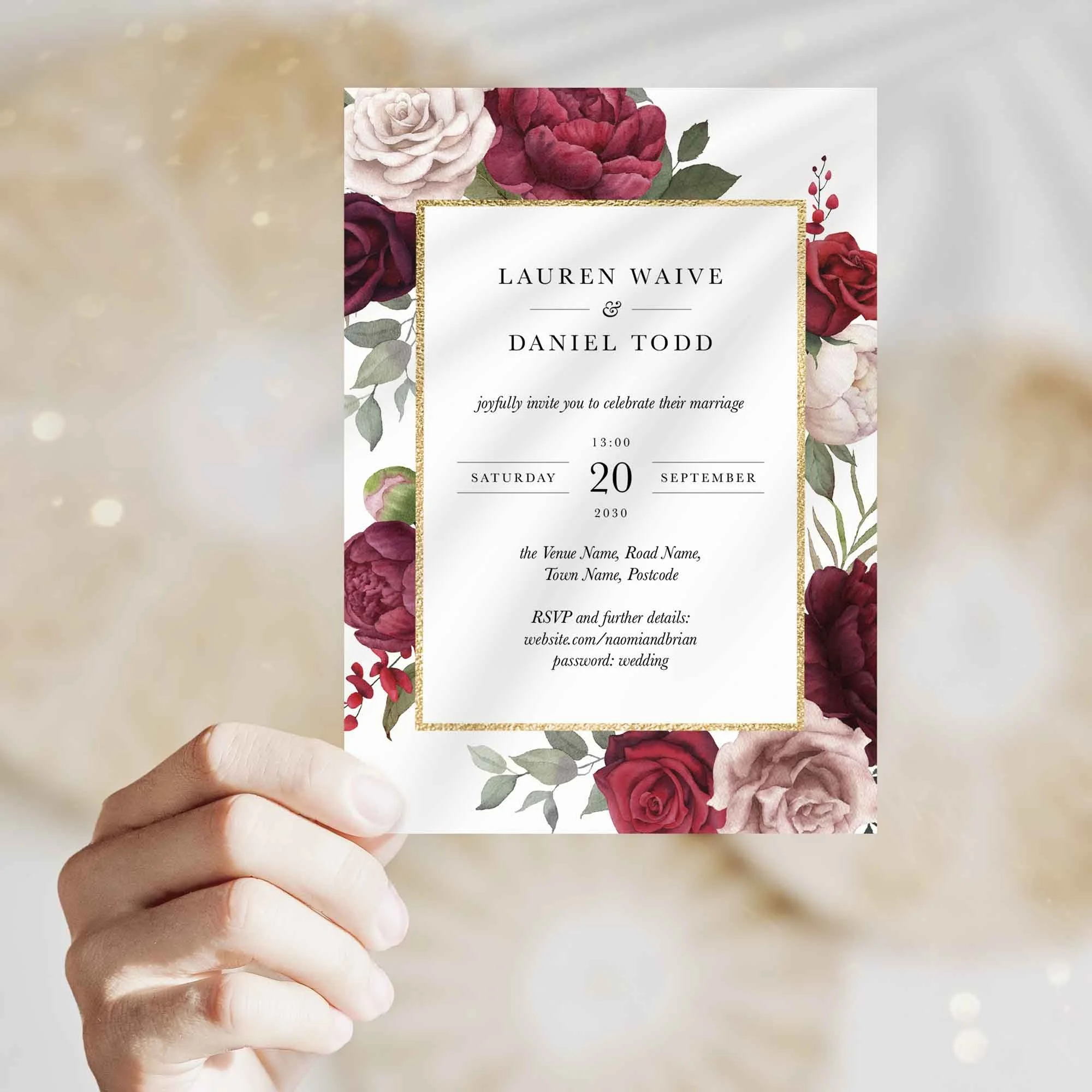 Hand holding Burgundy and Blush Floral wedding invitation showing size and printed design details